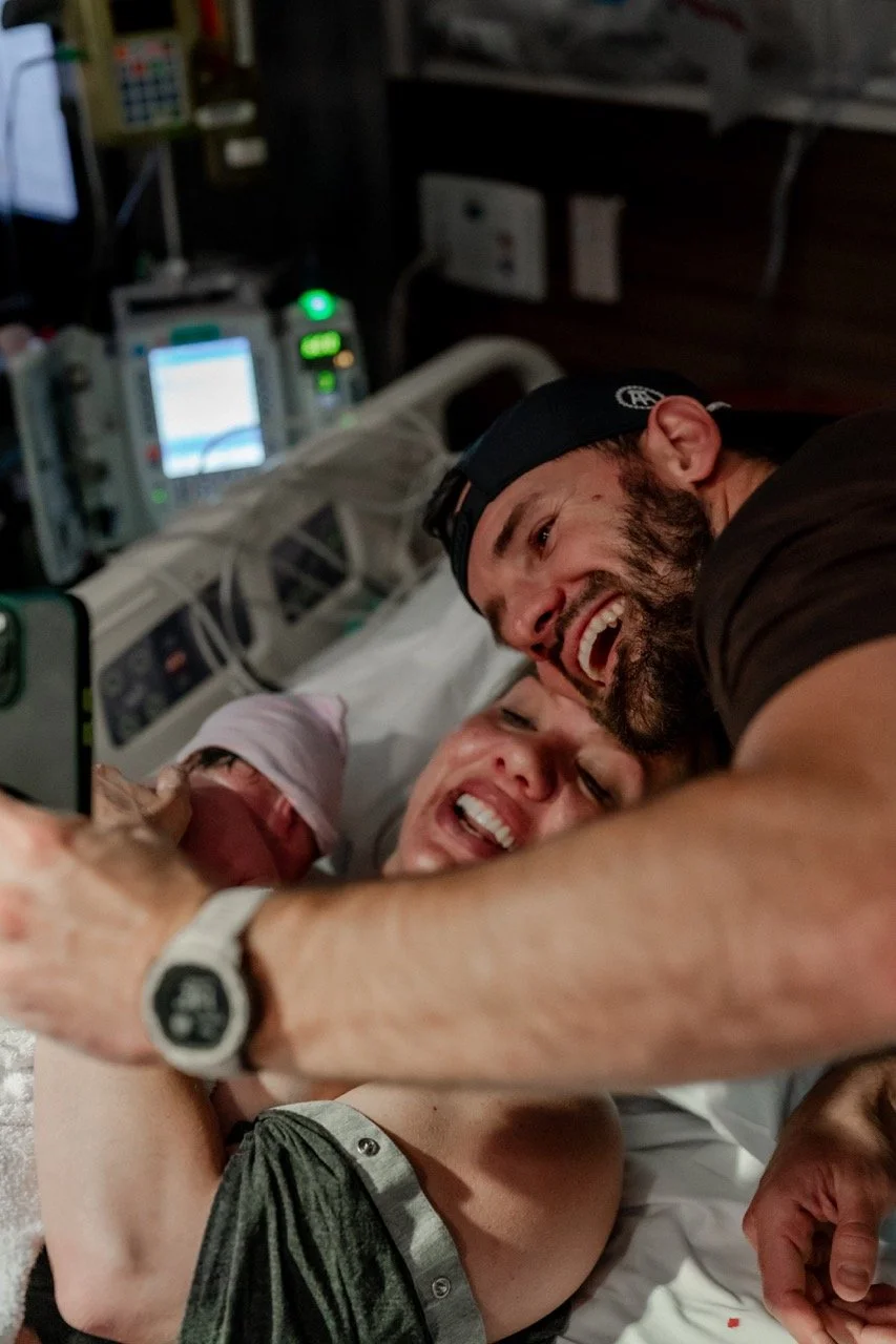 a family's first selfie in the hospital bed just after birth