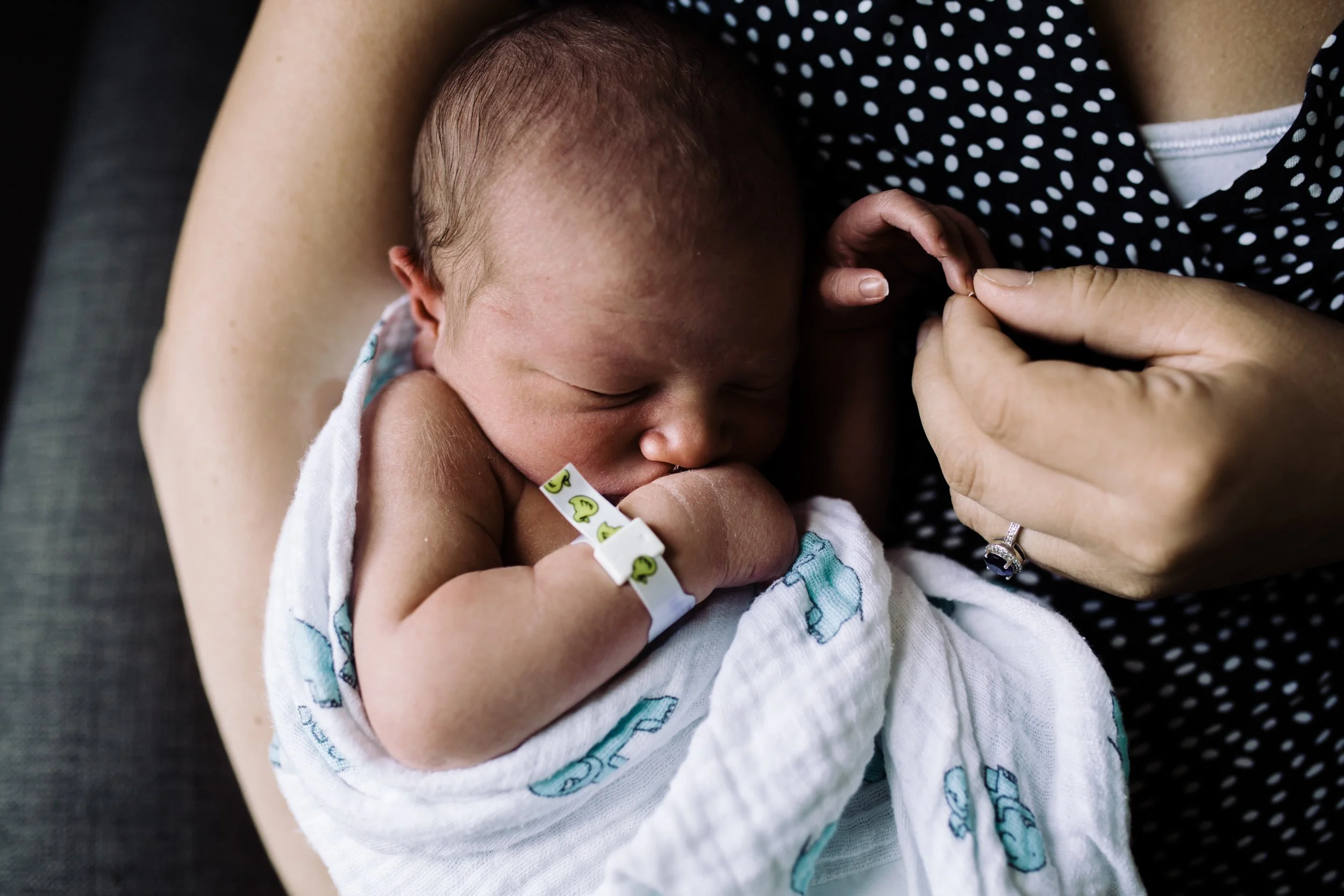 newborn baby being held by mom