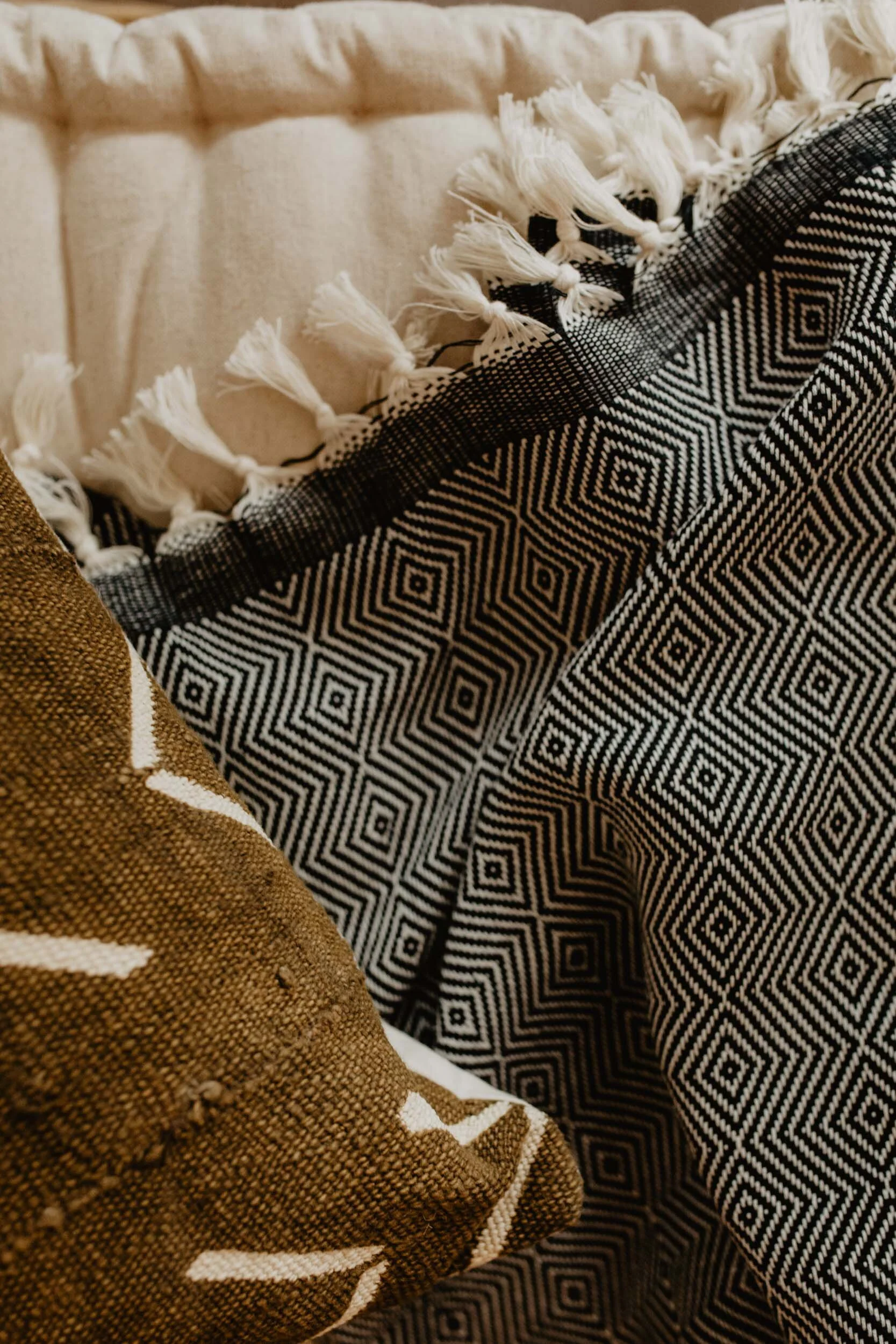 african mudcloth pillow and cambodia woven blanket