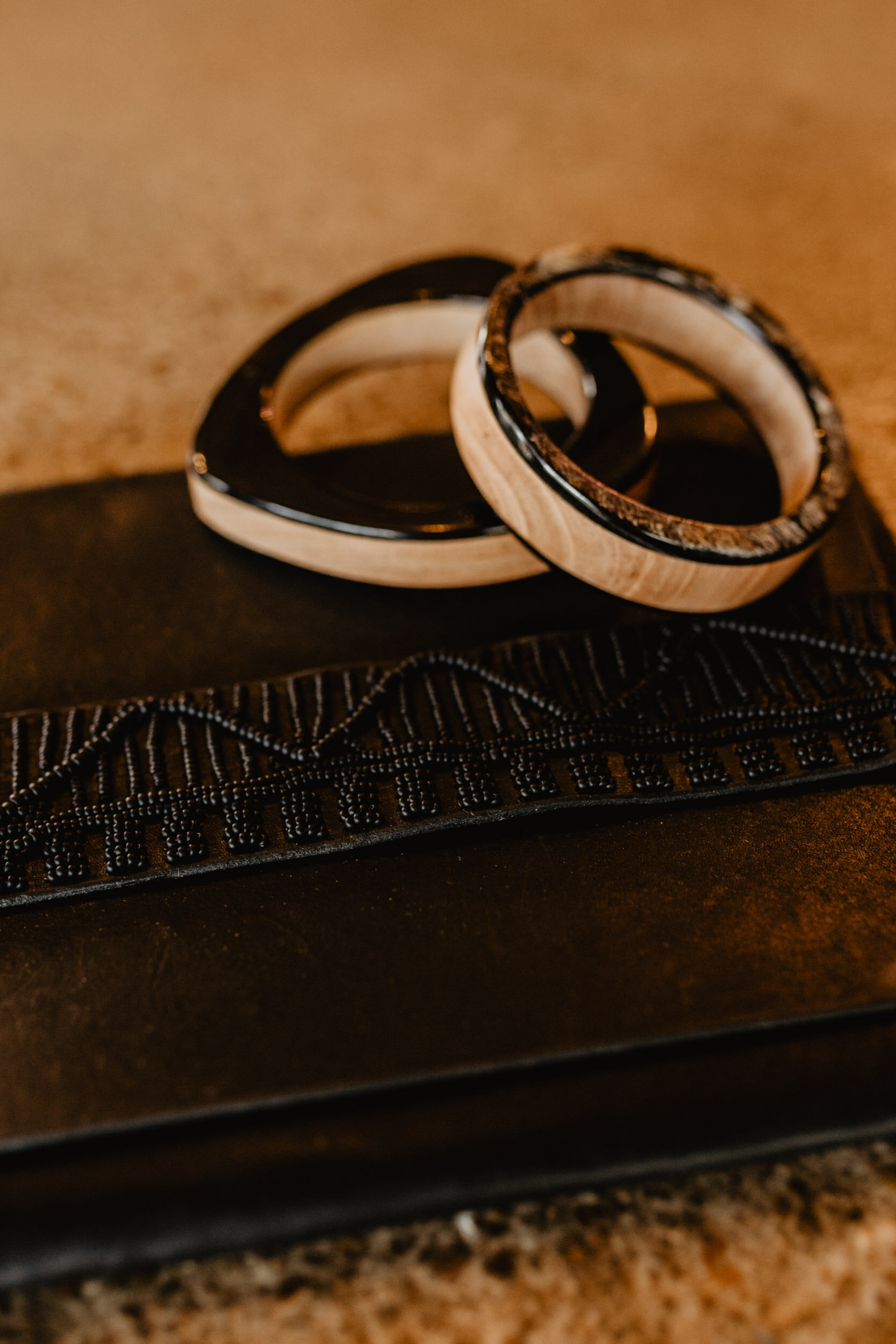 leather beaded clutch and horn and wood bracelets
