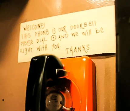 in the phone booth, dial 1 and the hostess will answer your call to check your reservation