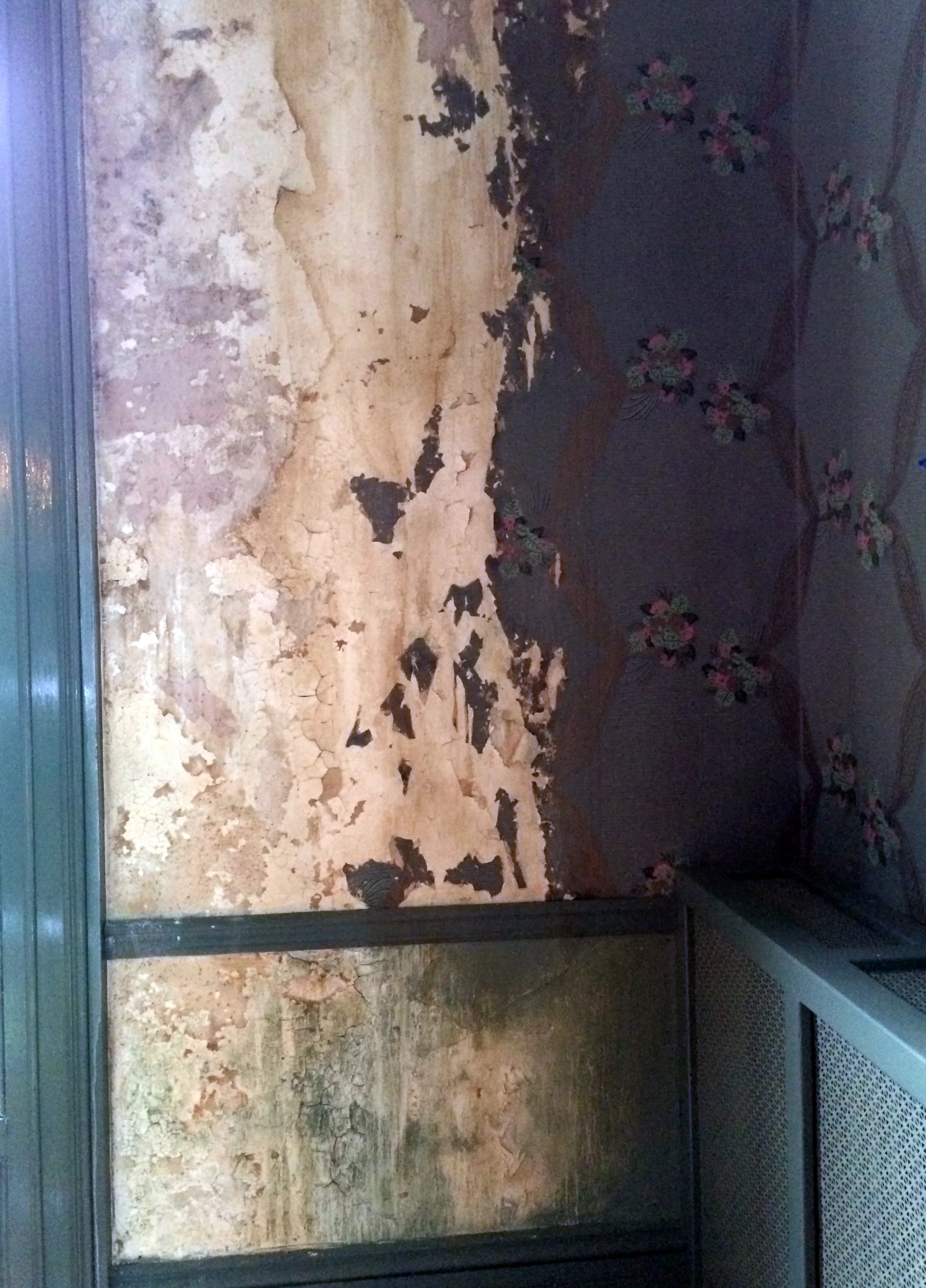 Faux water damage and peeling wallpaper damage for a film
