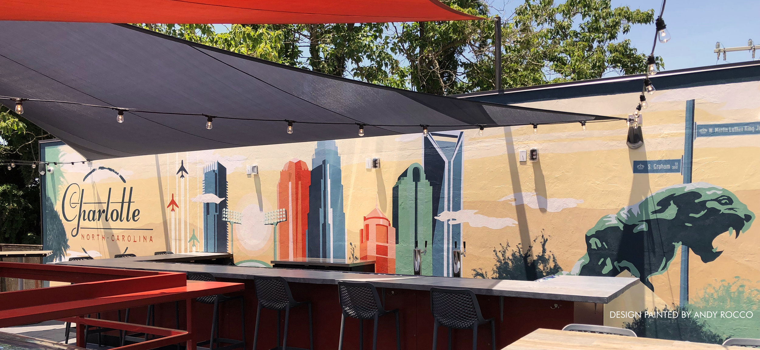 Rooftop Mural DesignIn preparation for Graham St's highly anticipated summer opening, I was asked to design a 40ft x 10ft mural for the backdrop of the rooftop bar. Other than requests to capture the Charlotte skyline in it’s entirety, the creative …