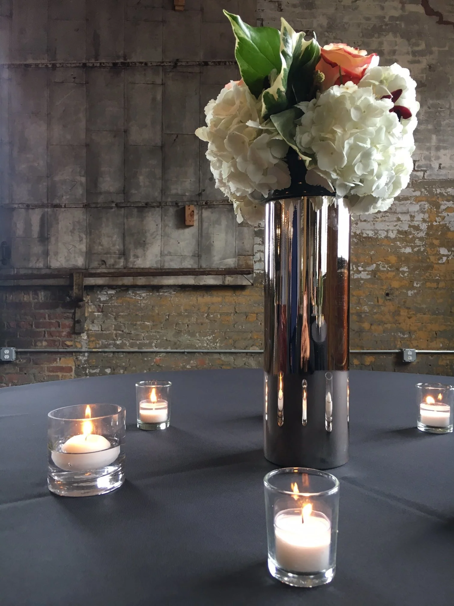 Levonne Inspirations tall vase with candles.jpg