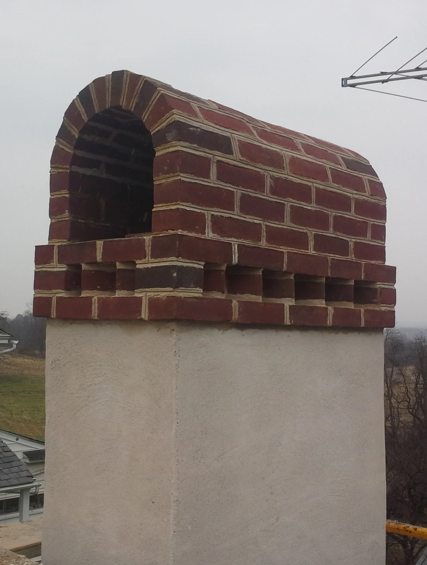 Stucco Chimney With Brick Bonnet