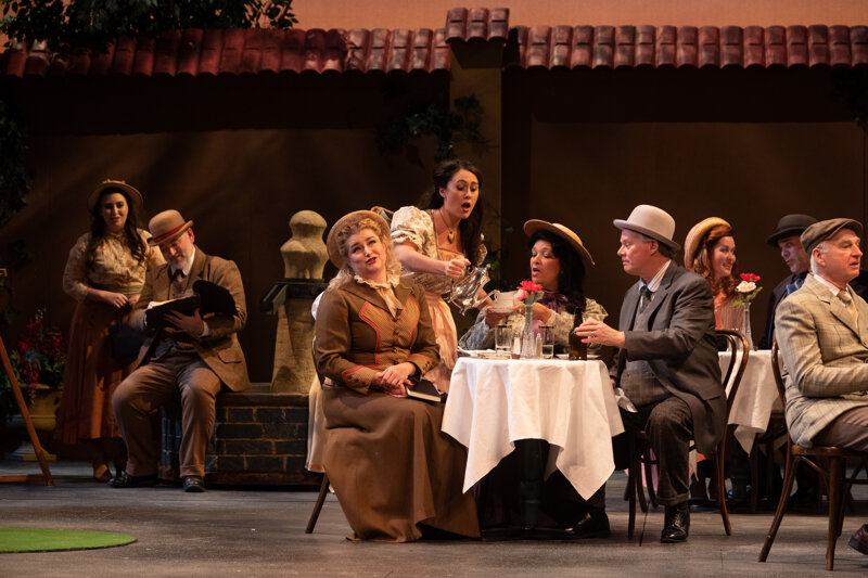  Katherine Fili as Giannetta (rear of center table); Indianapolis Opera Chorus  Photo Credit: Denis Ryan Kelly Jr. 