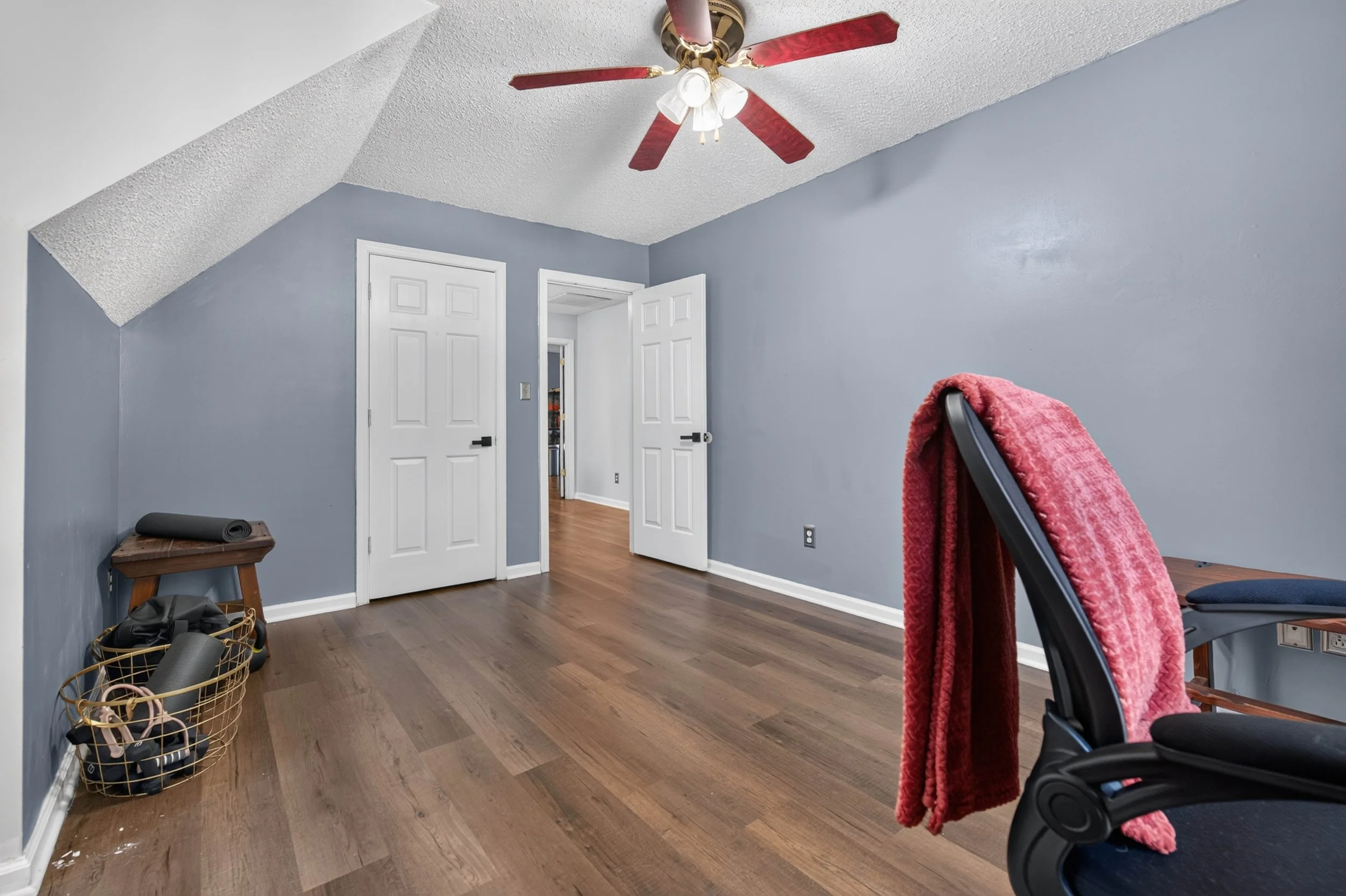 The third upstairs bedroom includes a closet and additional floor space beneath the dormer-style ceiling.