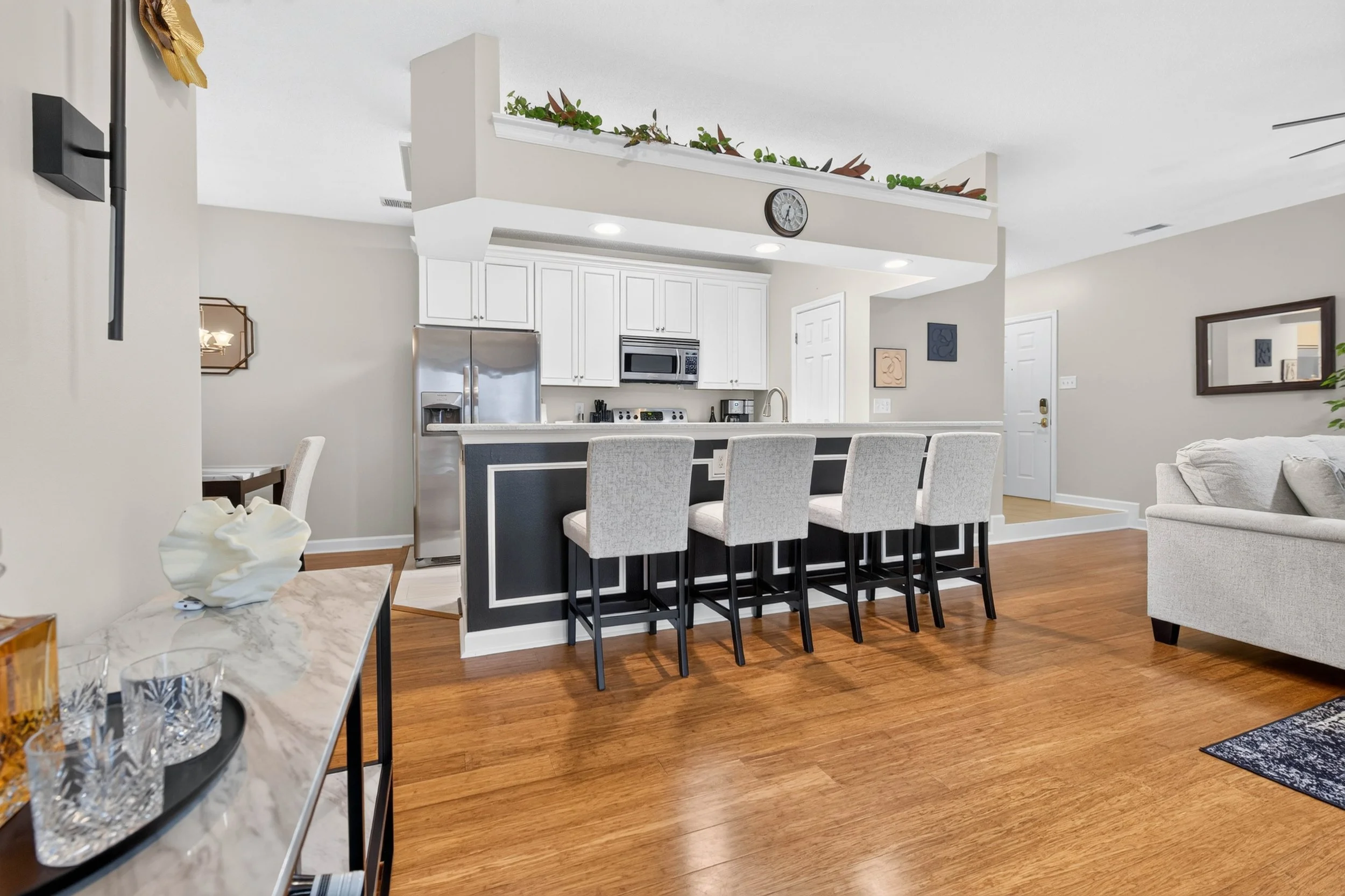 One clear sightline connects the kitchen, dining area, living room and private balcony, creating an easy sense of flow.