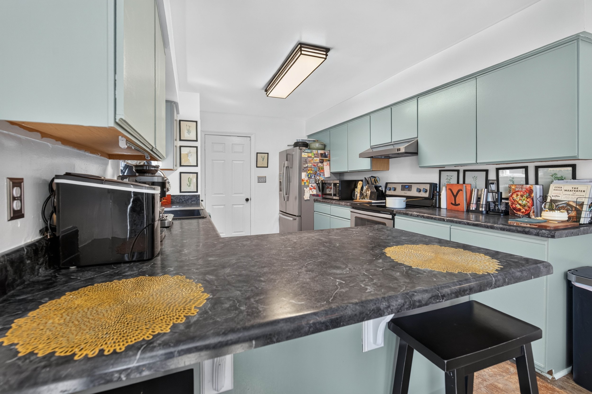 The breakfast bar and surrounding counters provide additional kitchen workspace.