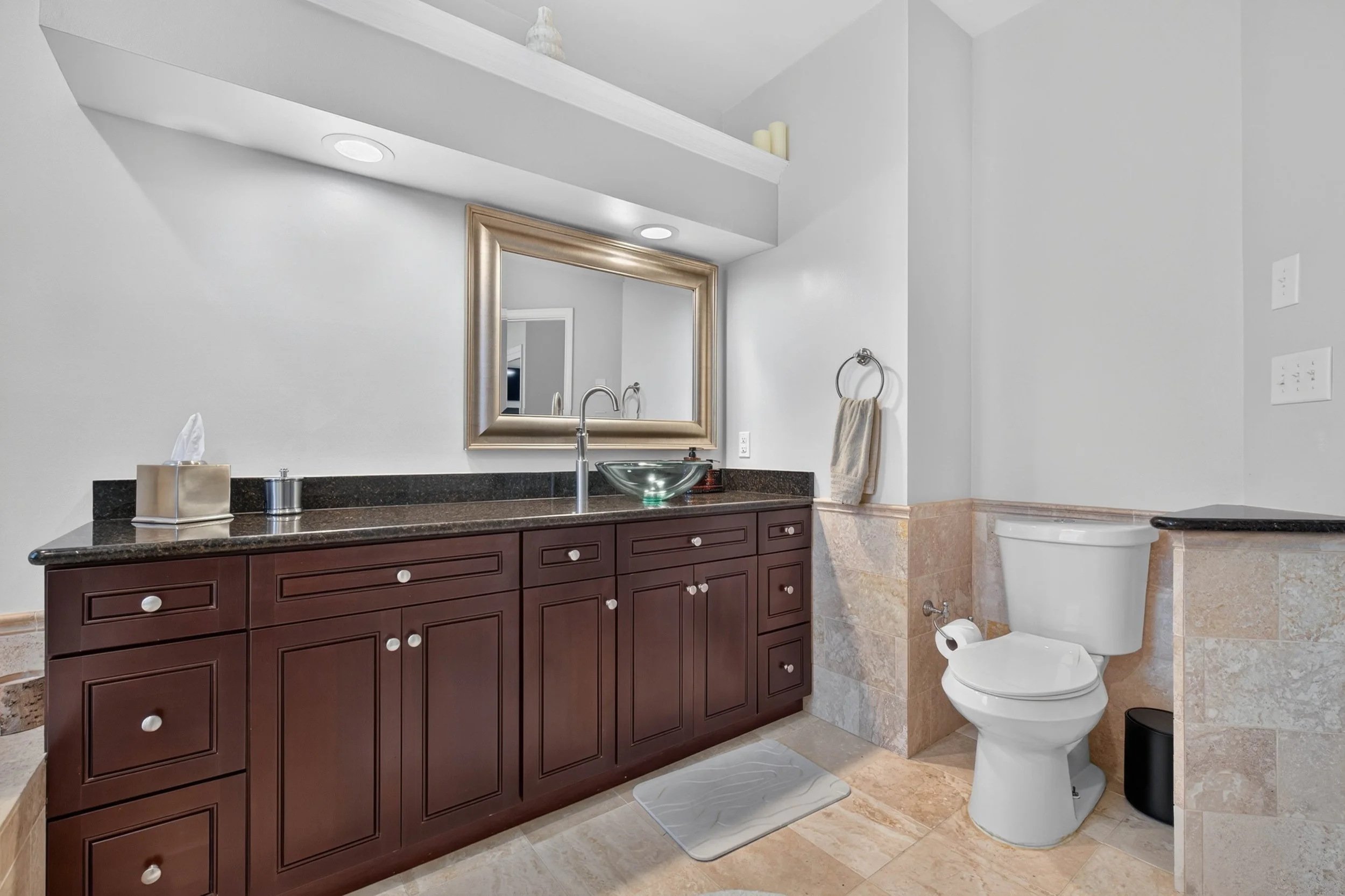 A long vanity provides generous counter space and room for two people to prepare for the day comfortably.