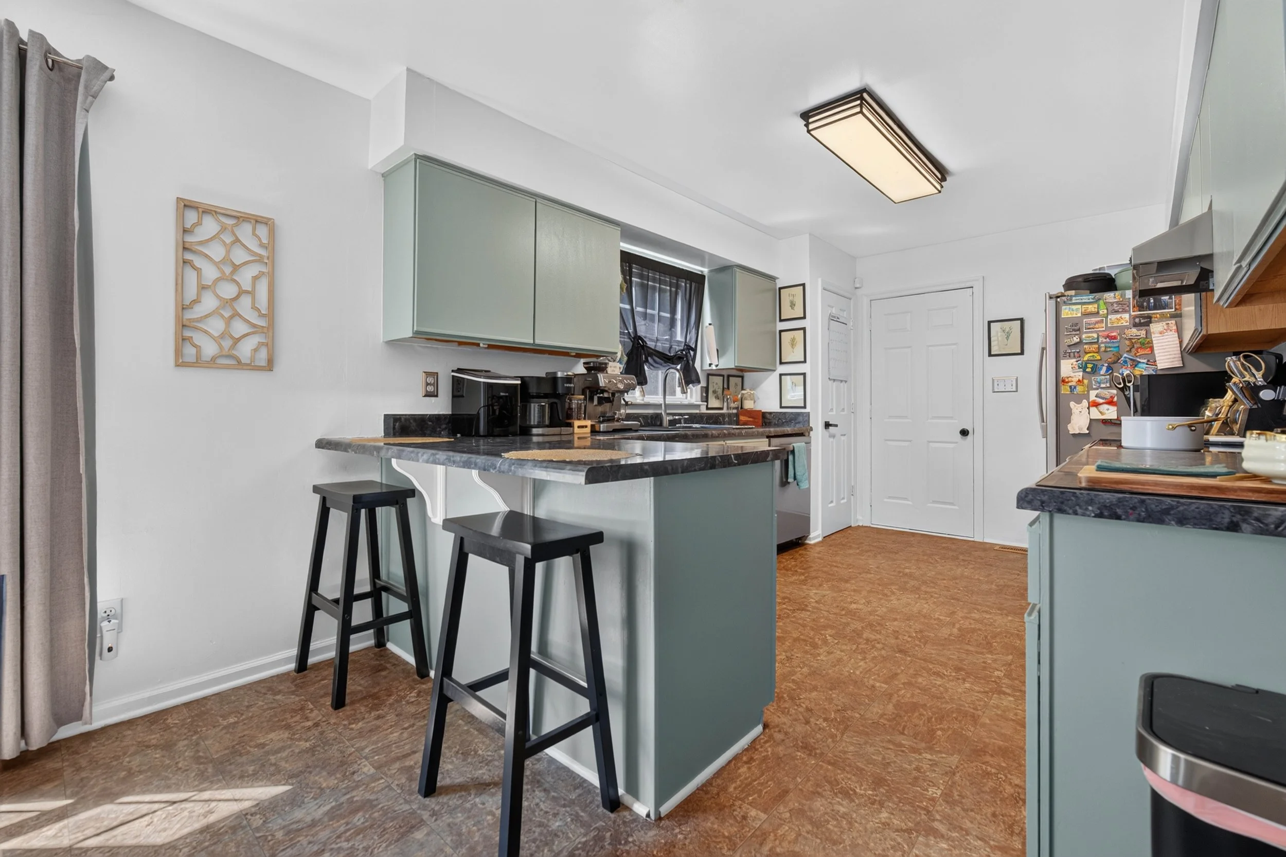 The breakfast bar adds space for quick meals while keeping the kitchen open to the room beyond.