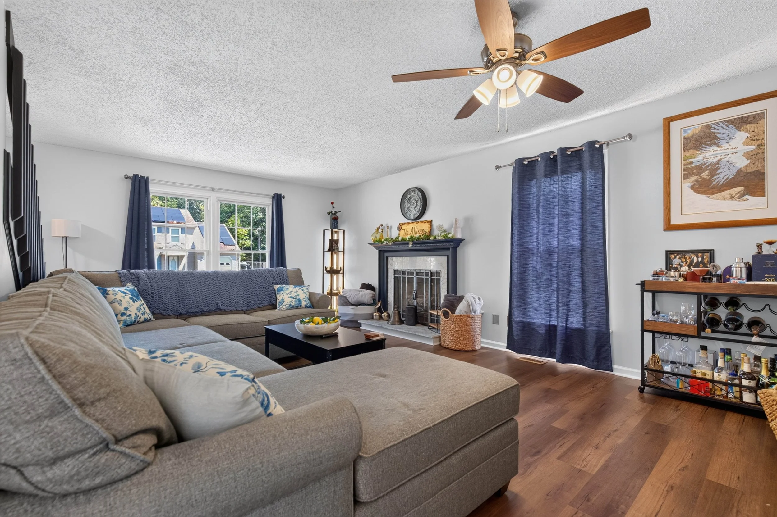 The living room has a fireplace, front-facing windows and an open connection to the dining area.