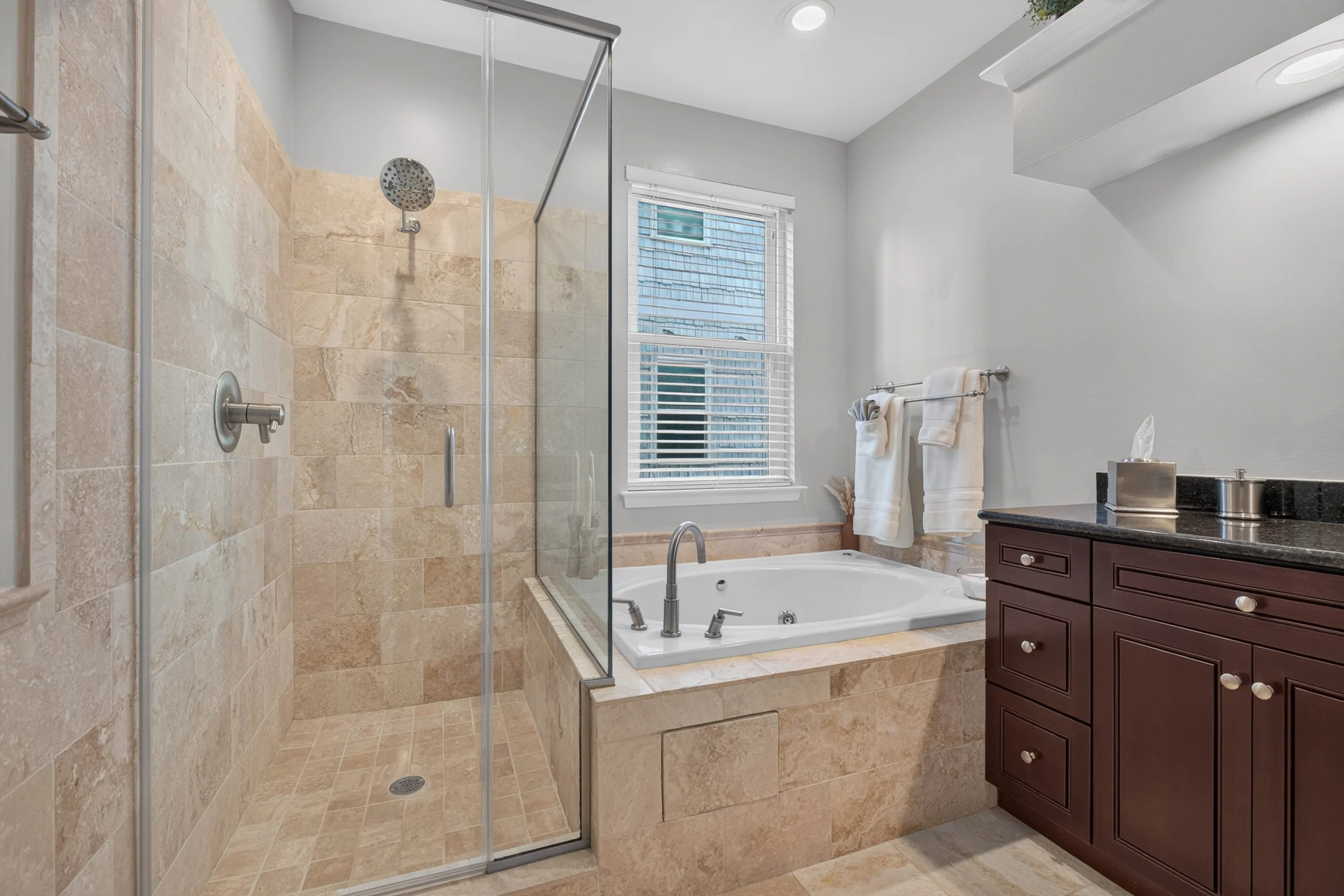 Coordinated tile and elevated finishes give the primary bathroom a polished, cohesive design.