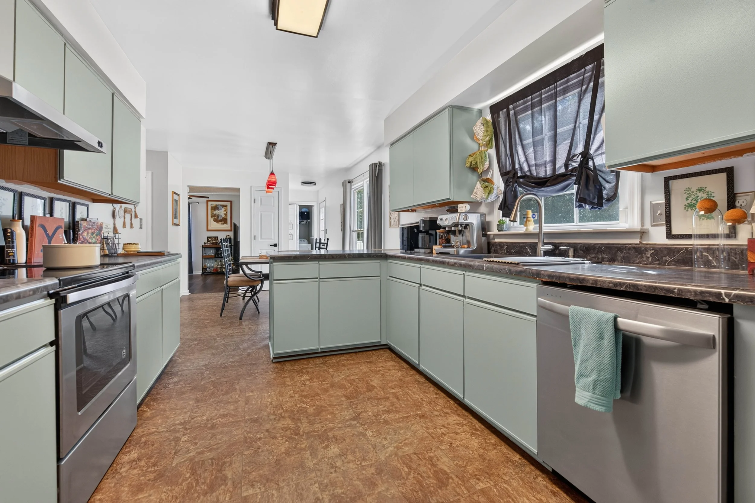 The kitchen has generous counter space, stainless appliances and a breakfast bar.