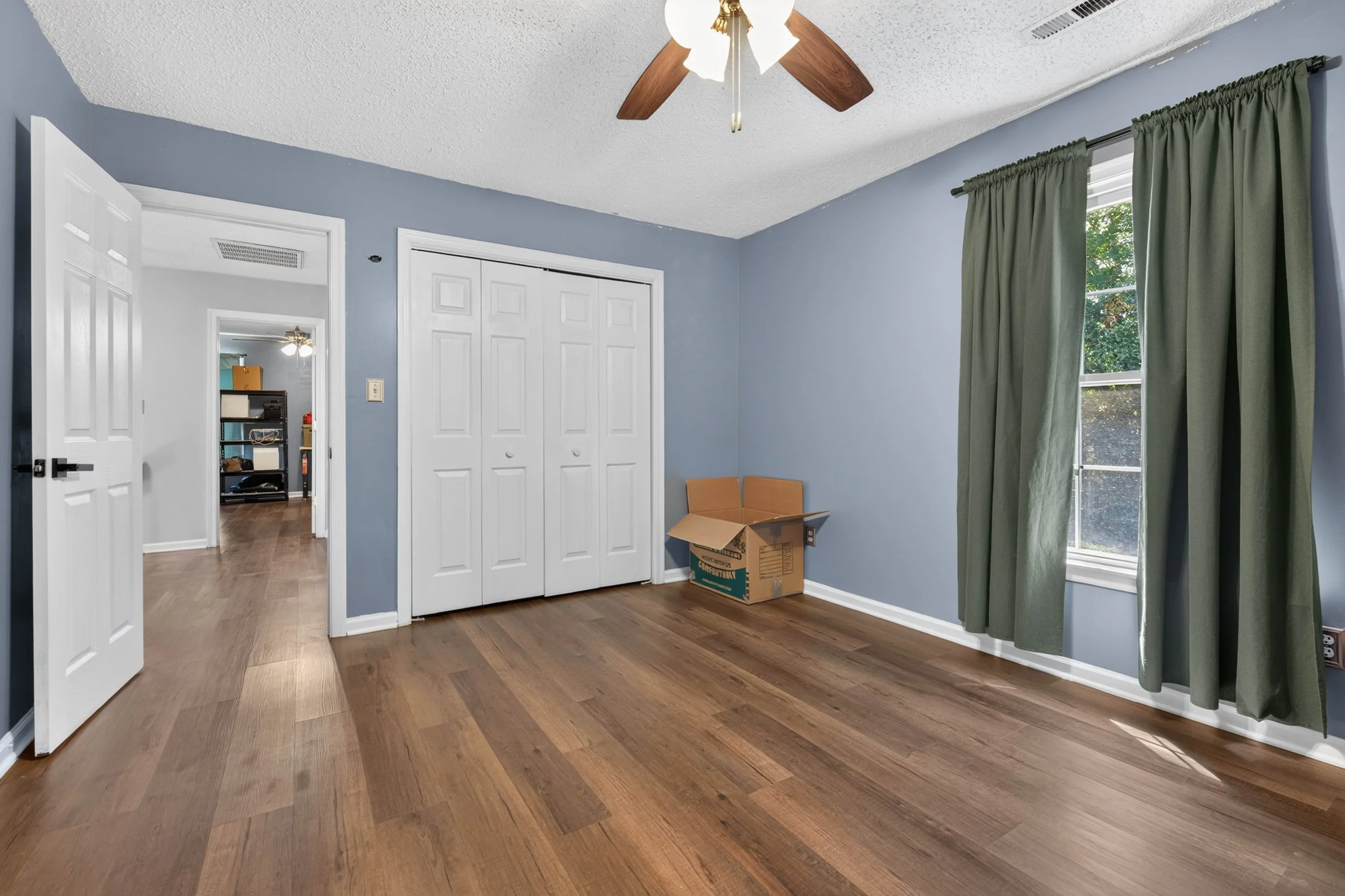 This upstairs bedroom includes a closet and enough open floor space to arrange it in different ways.