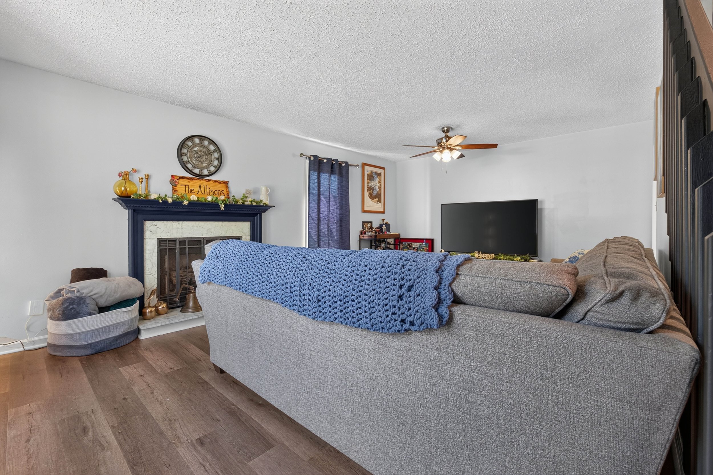 This living-room view shows the fireplace and the open connection to the dining area.