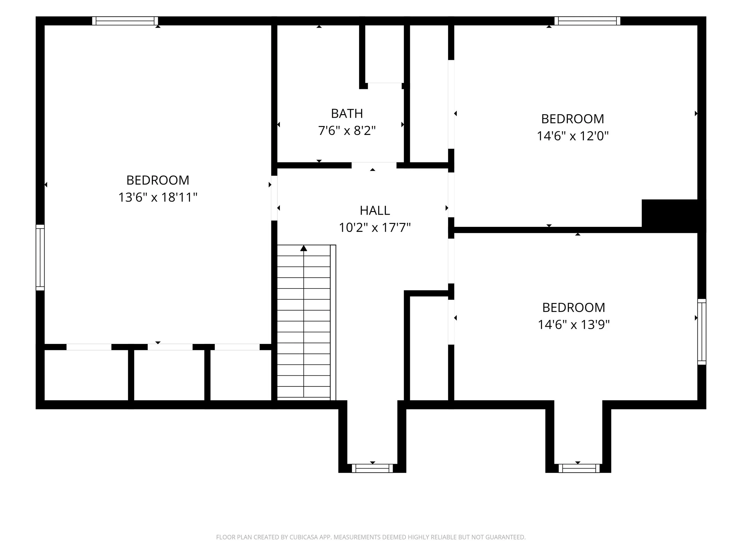 Main-level floor plan showing the living room, dining area, kitchen, first-floor primary bedroom, full bath and attached garage.