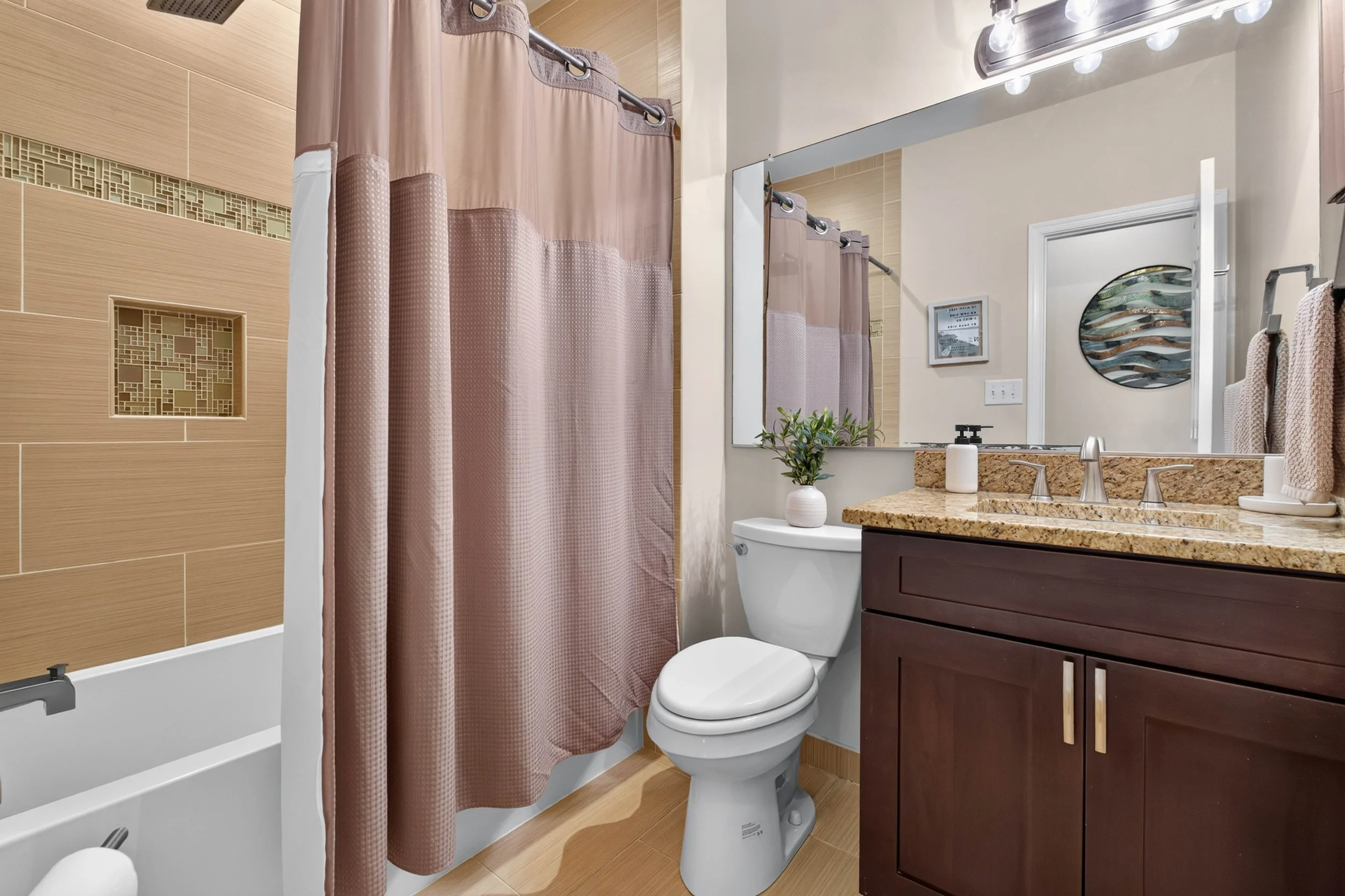The renovated hall bathroom carries the home’s polished finish level into both guest and everyday spaces.