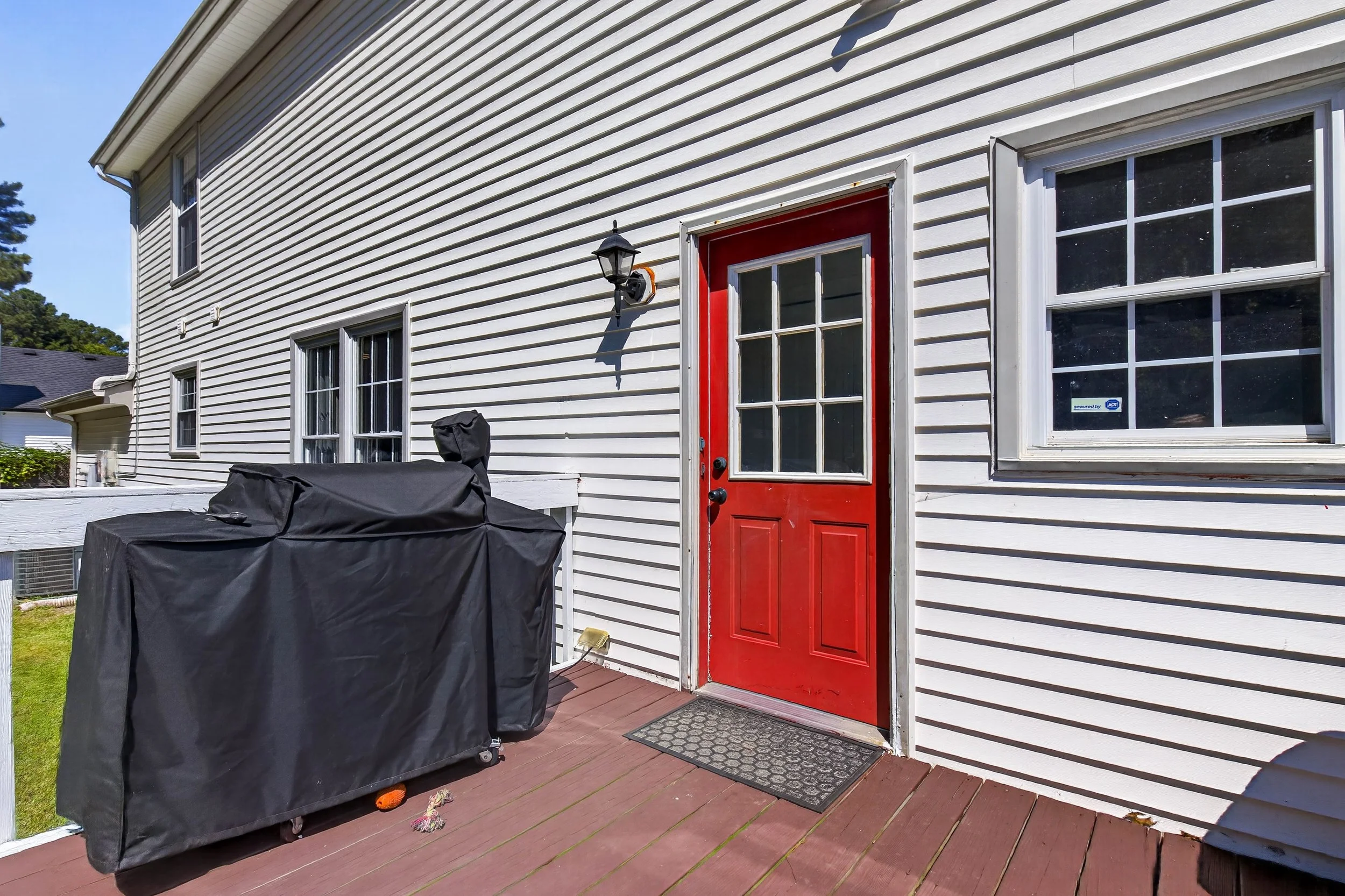 The rear door opens directly onto the deck and fenced backyard.