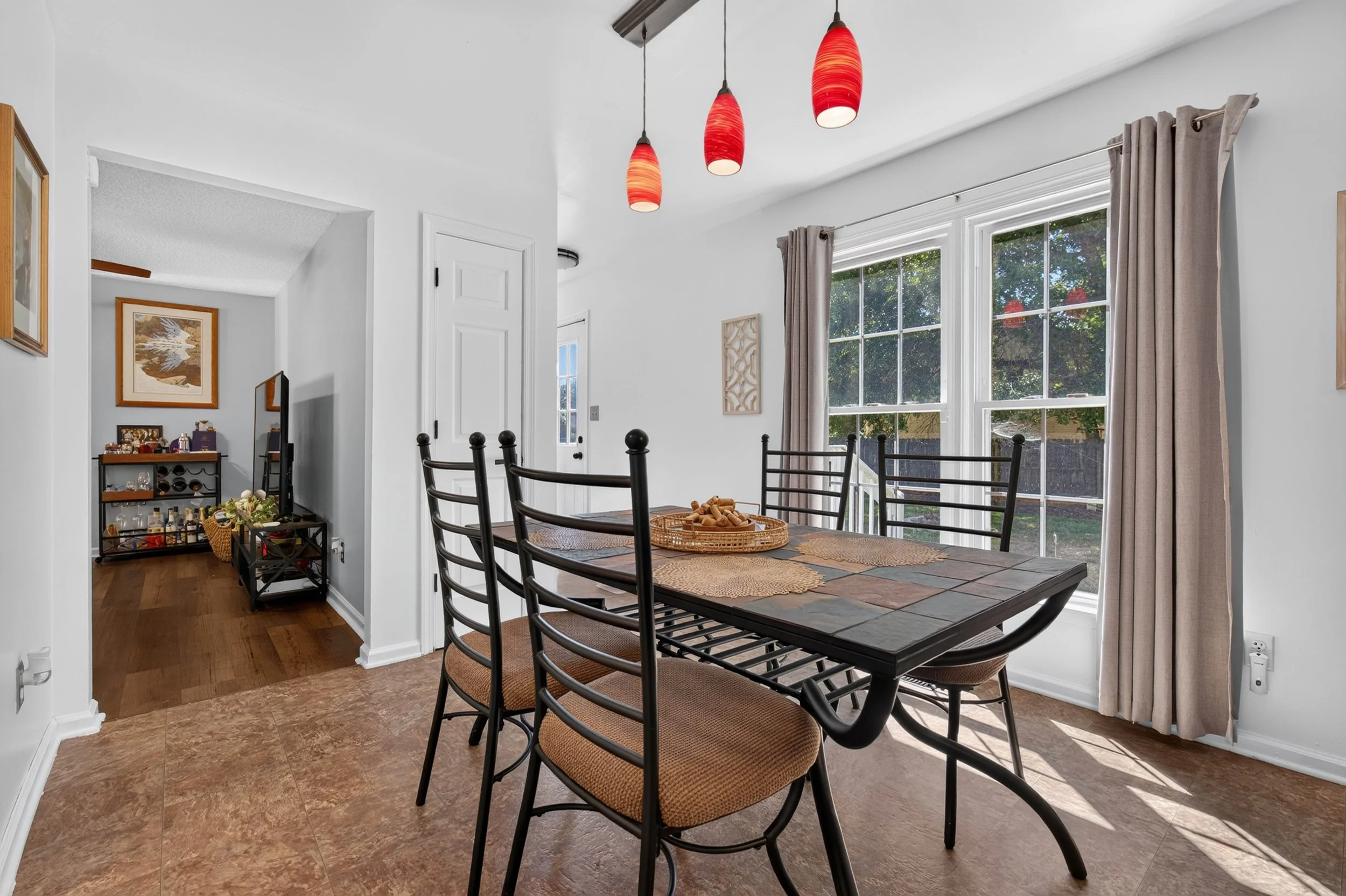 Natural light reaches the dining area through the glass doors and nearby windows.