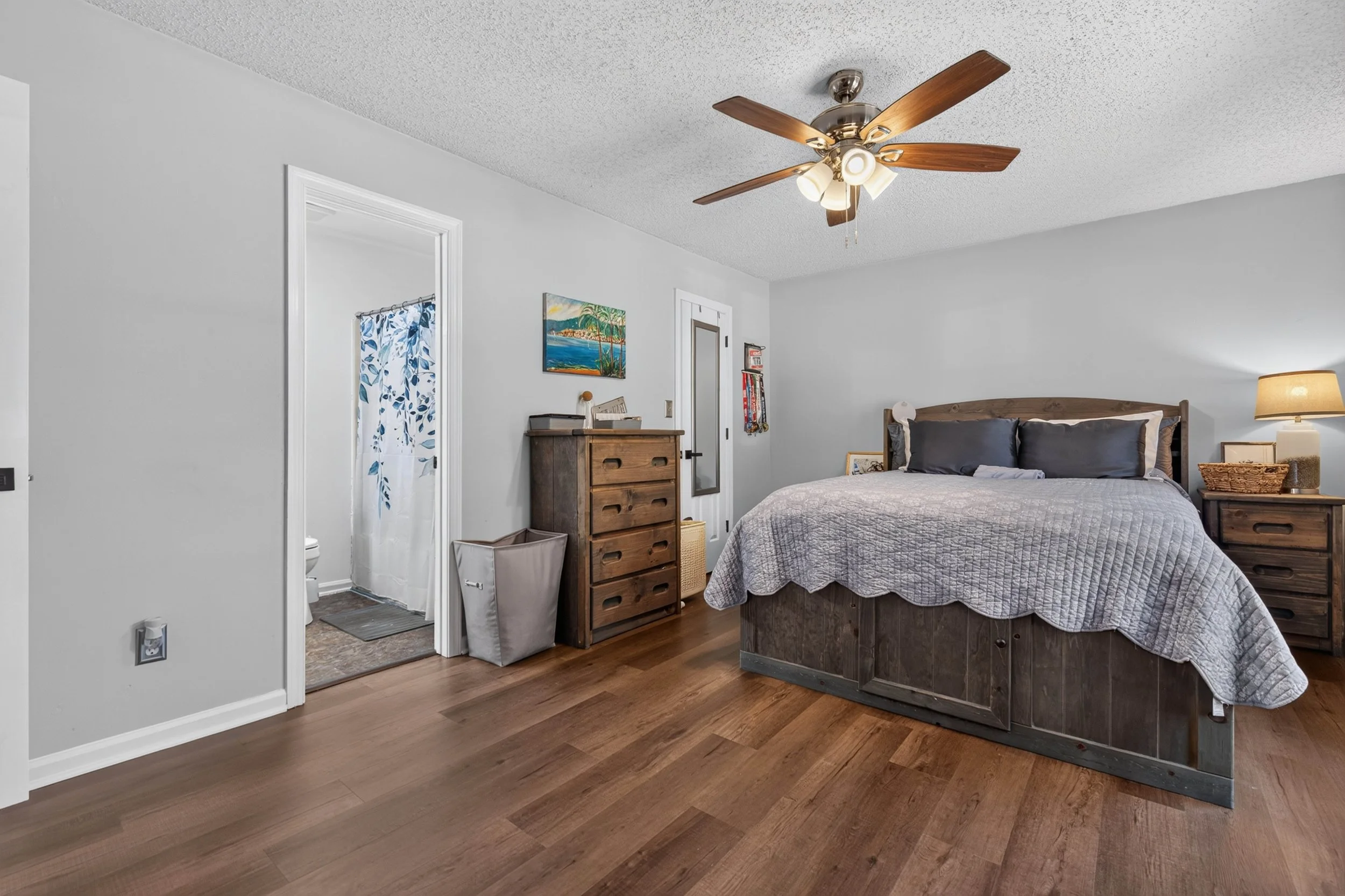 The first-floor primary bedroom includes natural light and access to a walk-in closet.