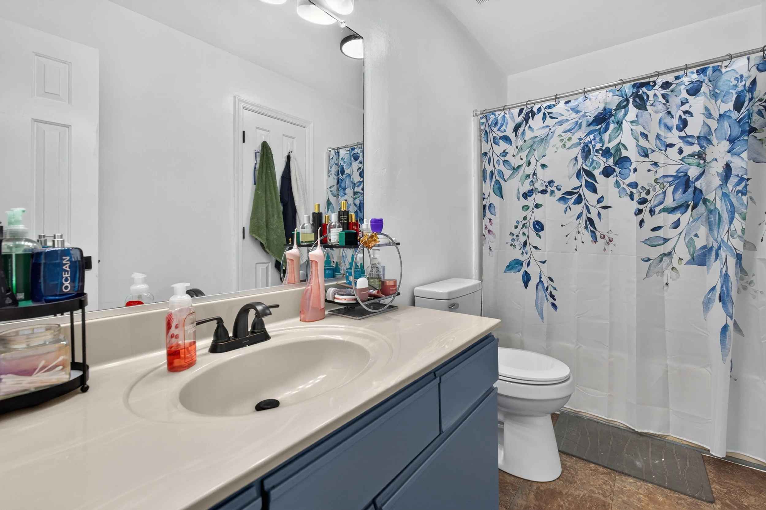 The main-level full bathroom includes a wide vanity and a tub-shower combination.