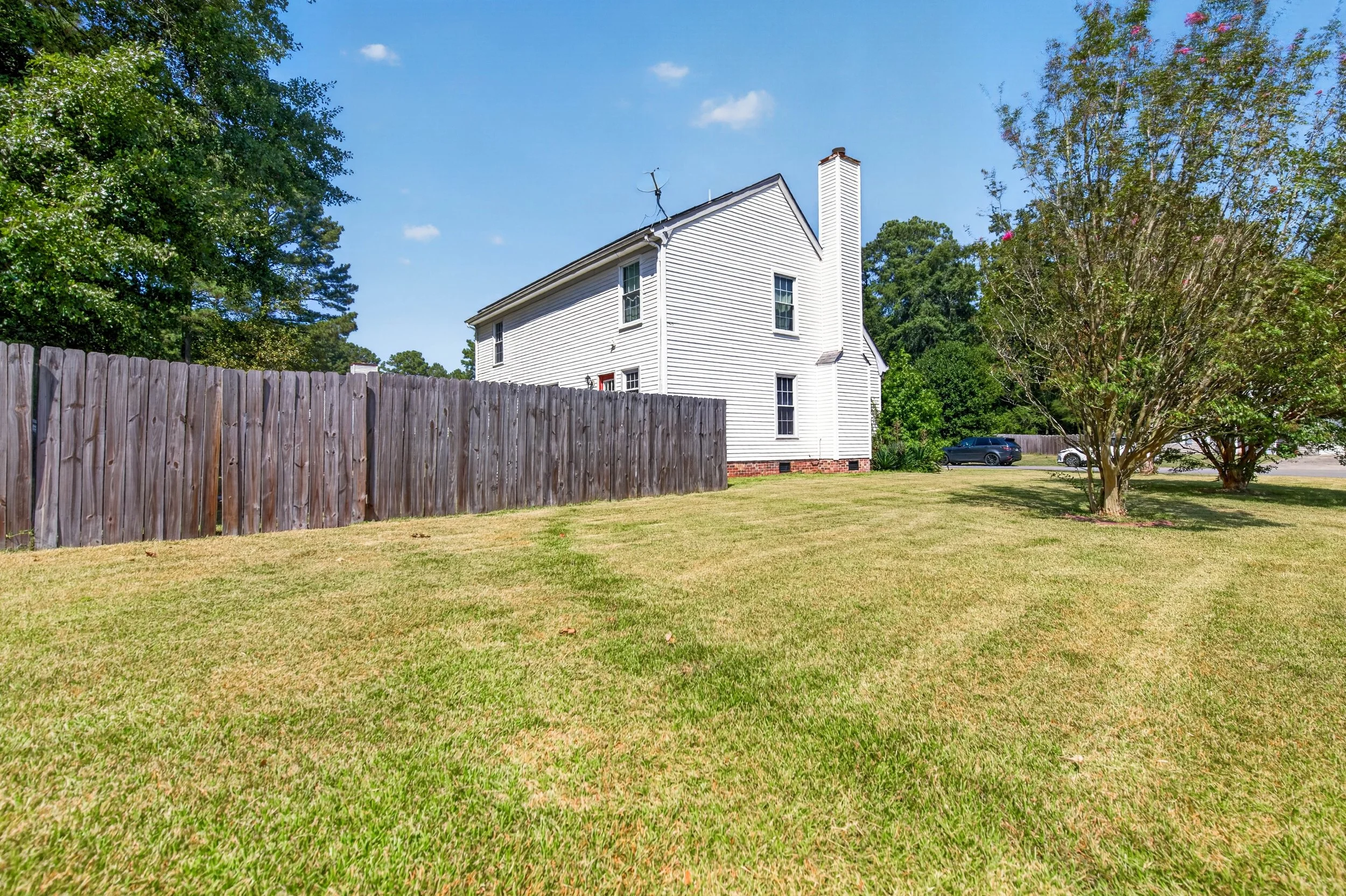 The side and rear yard wrap around the home within the privacy fence.