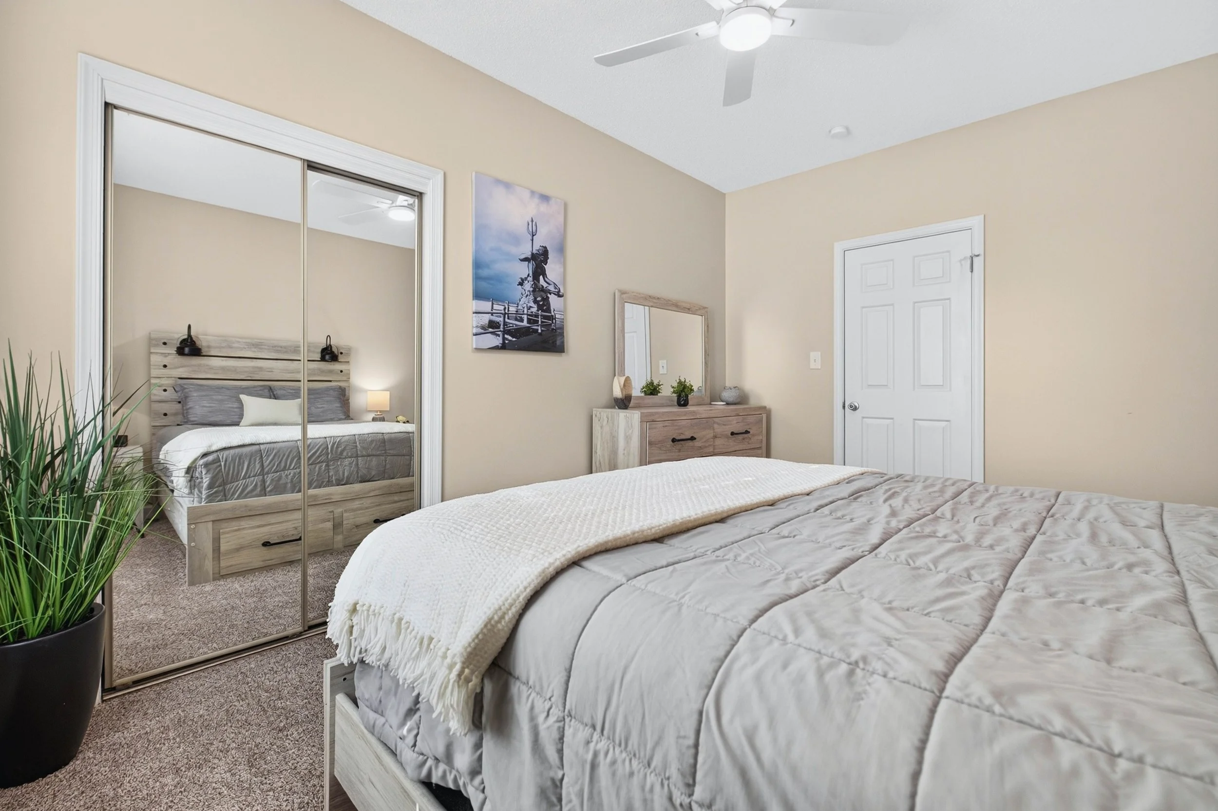 Mirrored closet doors reflect the natural light and enhance the open feeling of the second bedroom.