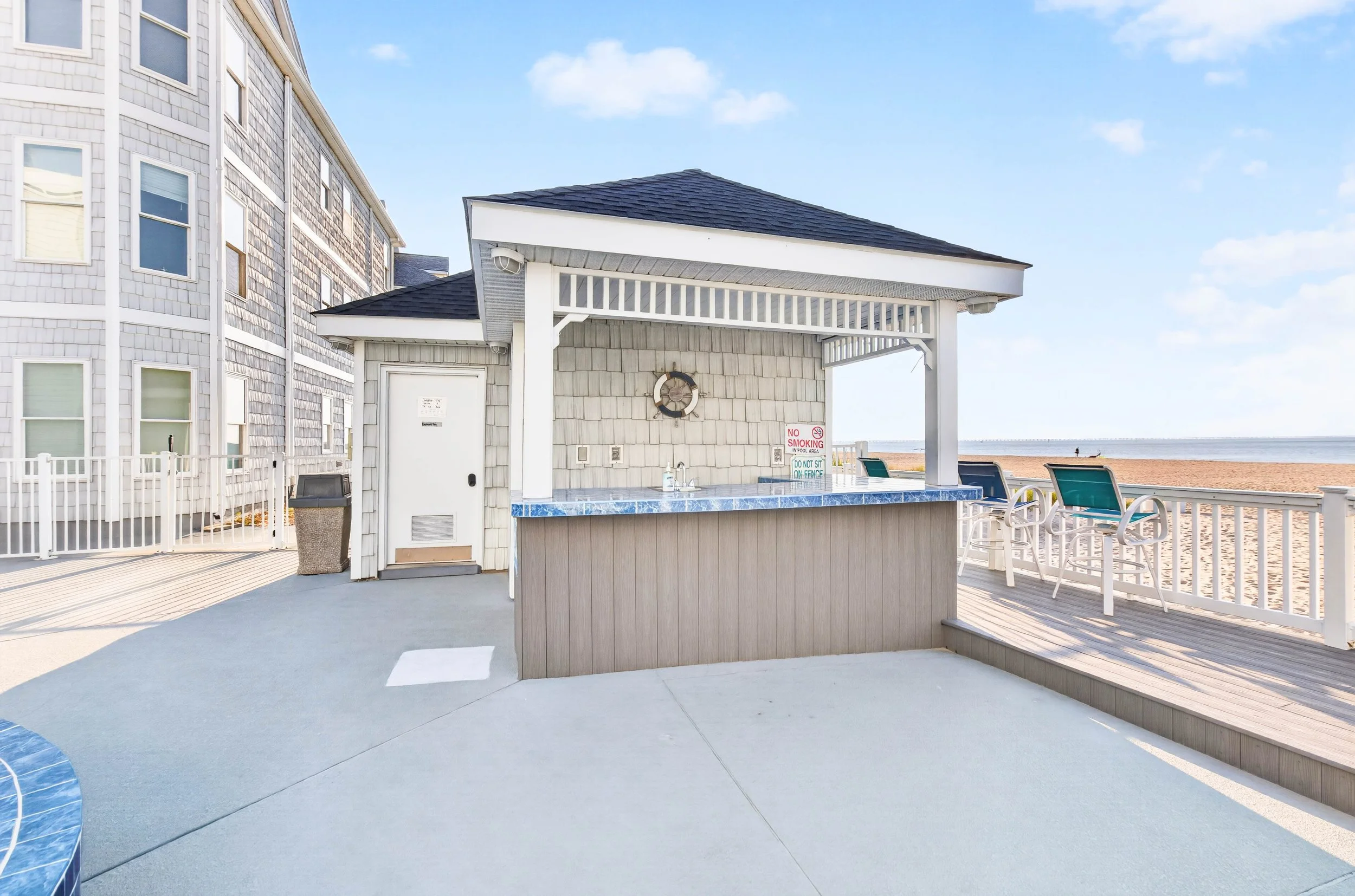 The community cabana and bar provide a shaded gathering place for pool days, cold drinks and conversation.