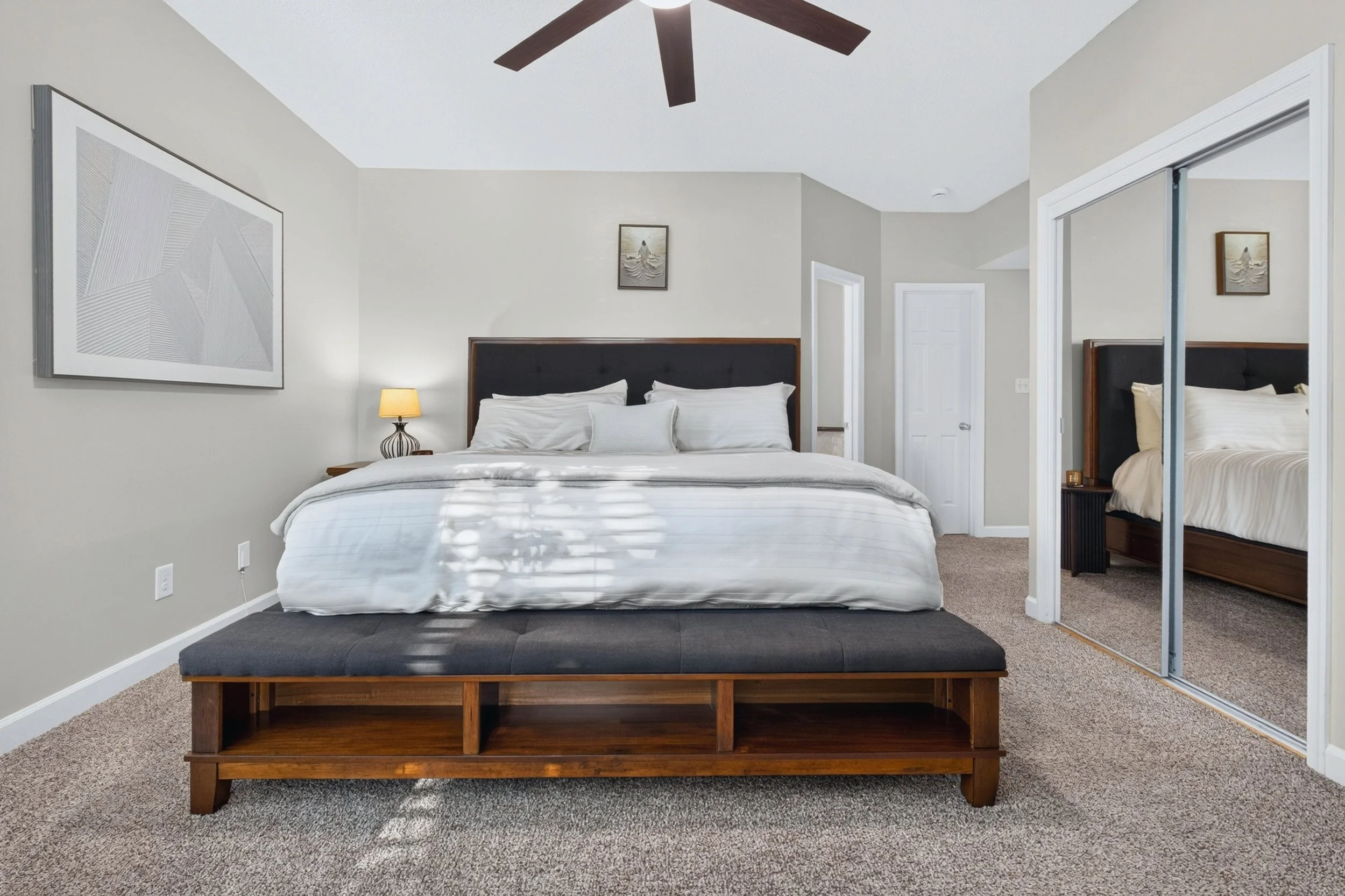 The bedroom, walk-in closet and renovated bath come together to create a comfortable primary suite.