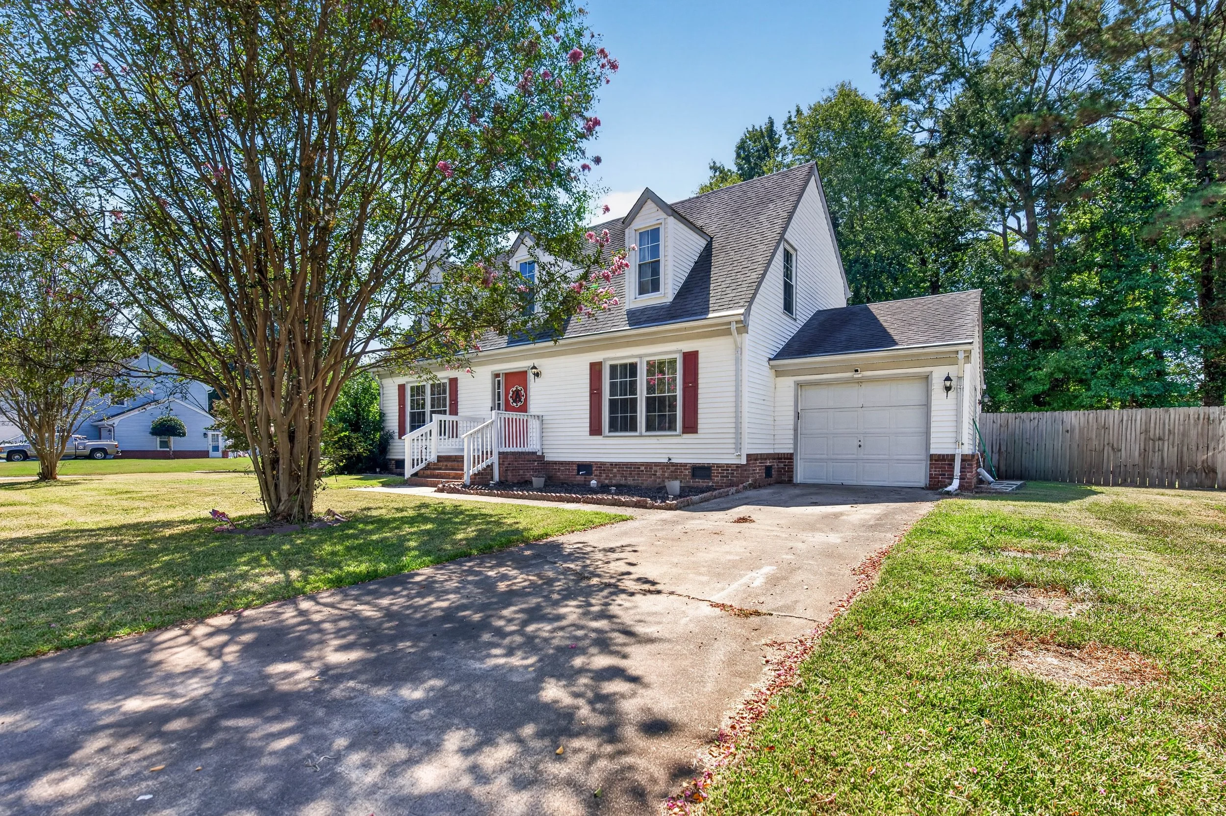 The attached garage sits beside the main entrance, with driveway parking in front.
