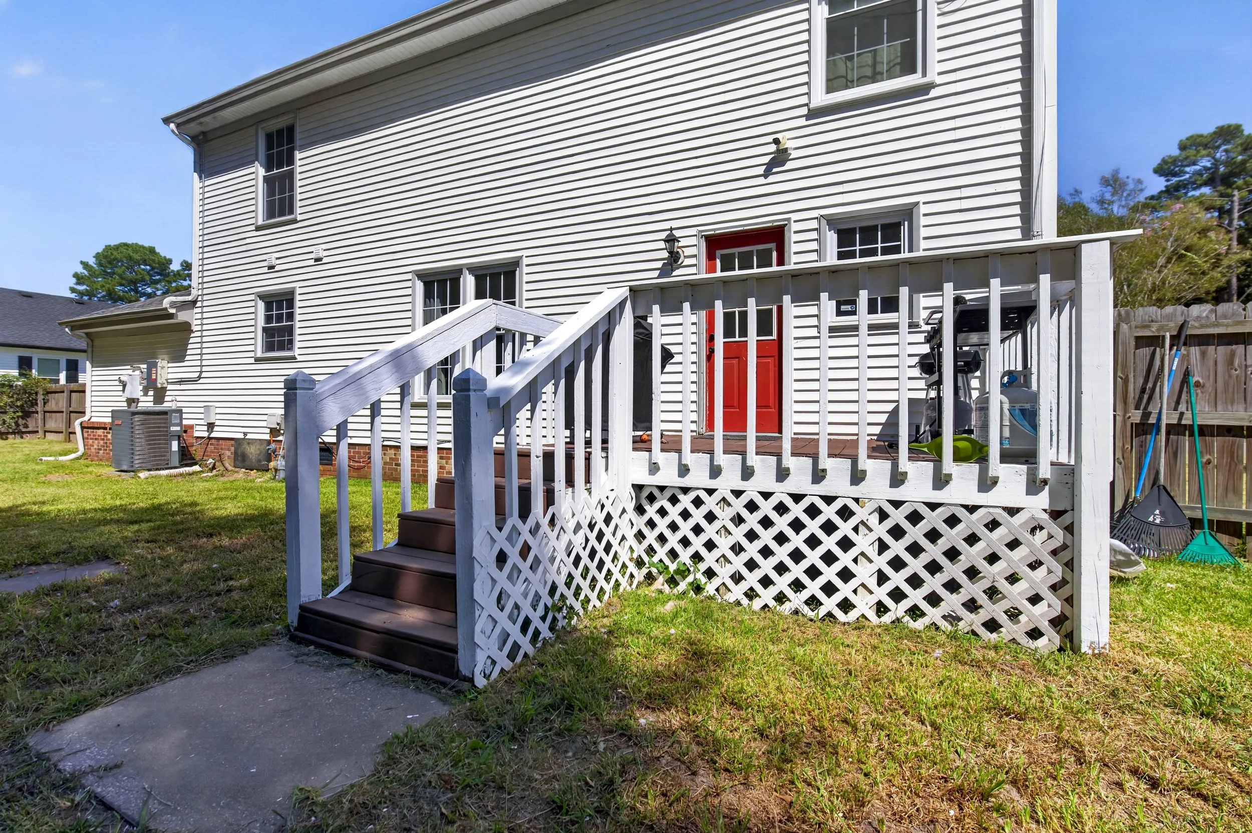 The deck connects directly to the home and overlooks the fenced backyard.