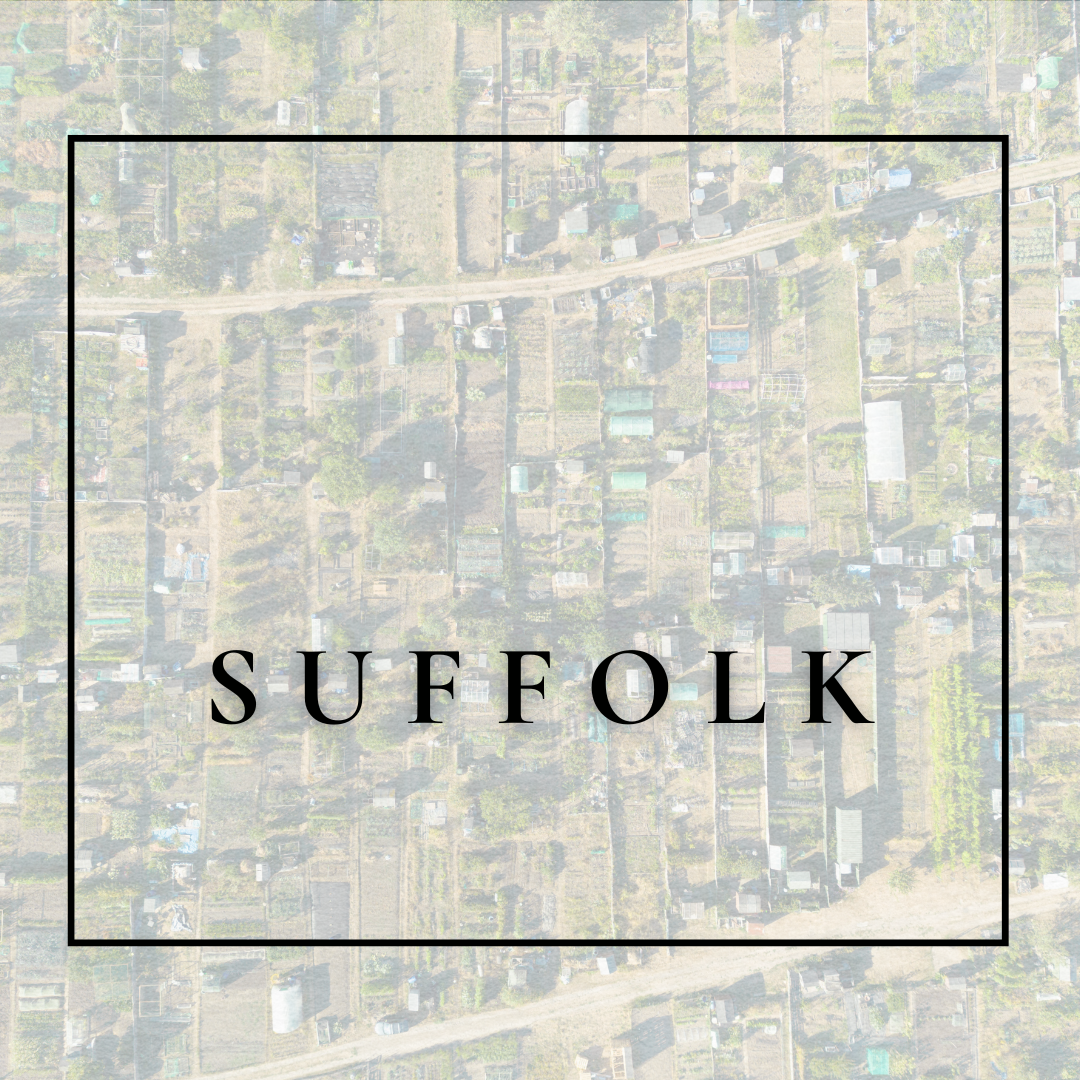 Aerial view of residential area with houses and gardens, overlaid with the text 'SUFFOLK' in black capital letters inside a black border.
