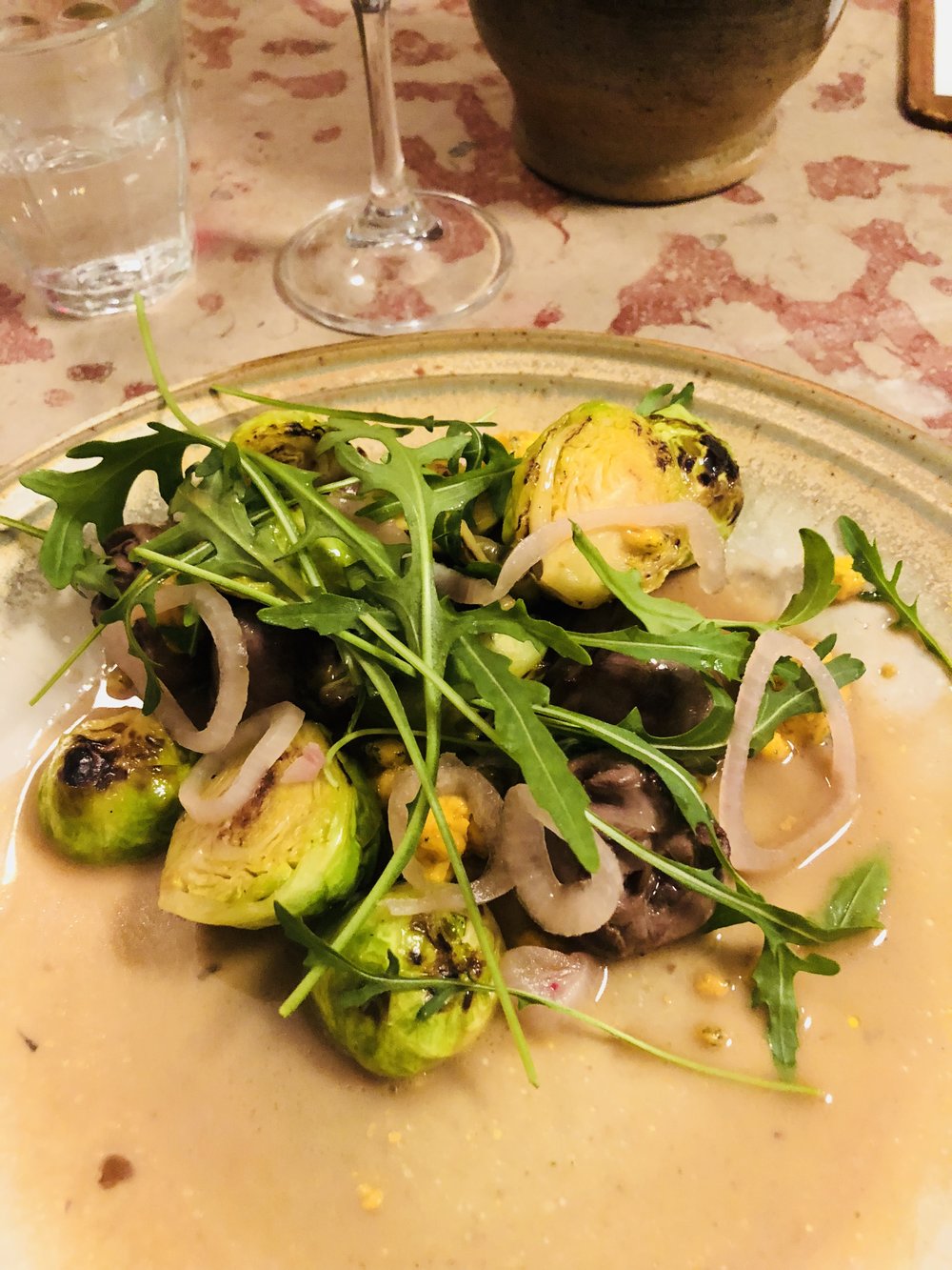 Sauteed Duck Hearts with Pan Roasted Brussels Sprouts, Pickled Onion, and Micro Greens