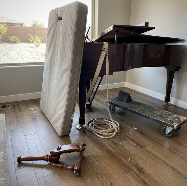 How a Grand Piano Is Moved on a Piano Board, Leg by Leg
