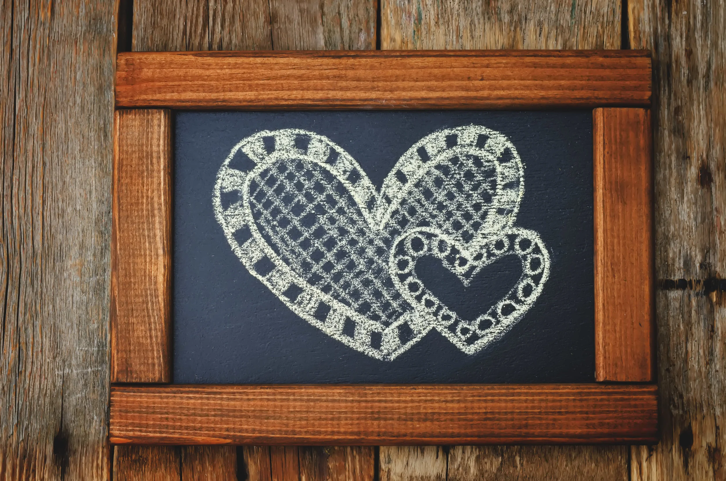 two-hearts-drawn-on-a-chalkboard-PJTKJAK.jpg