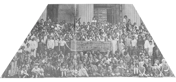Peoples Temple members gathered with a banner advertising Jim Jones and Peoples Temple in San Francisco 1972. Photo courtesy of Laura Johnston Kohl via Peoples Temple/Jonestown Gallery (Flickr)
