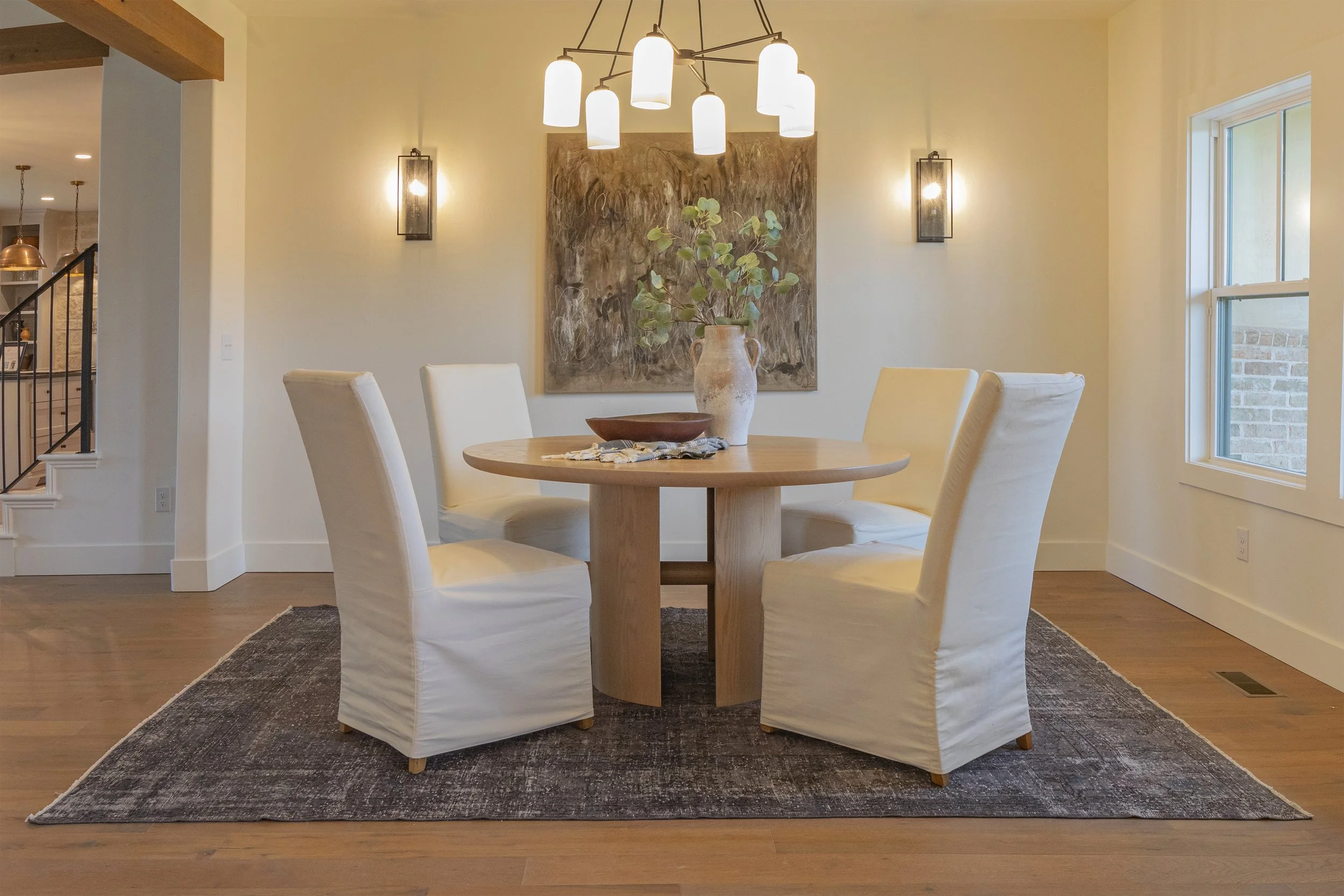 Round white oak ding table in an Okc show home