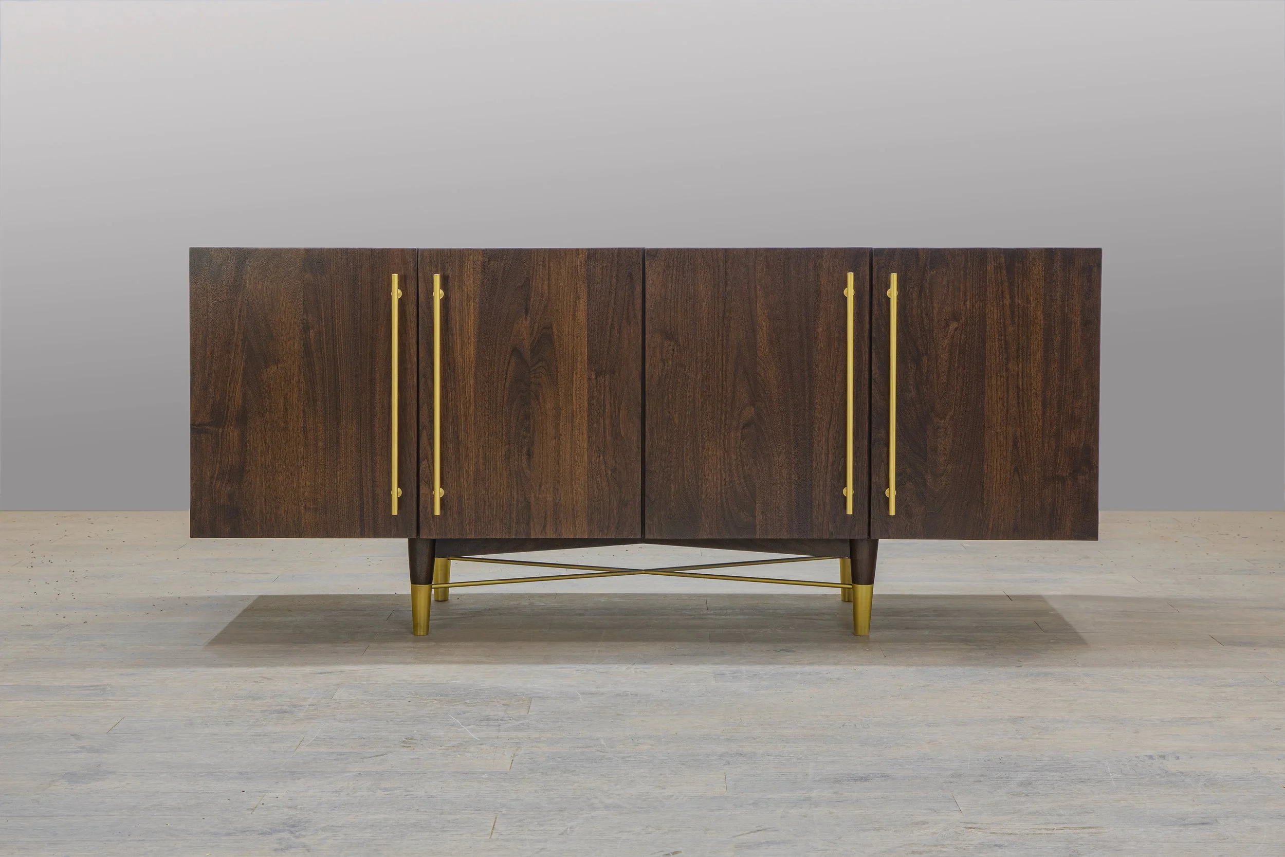 Walnut media console with brass accent
