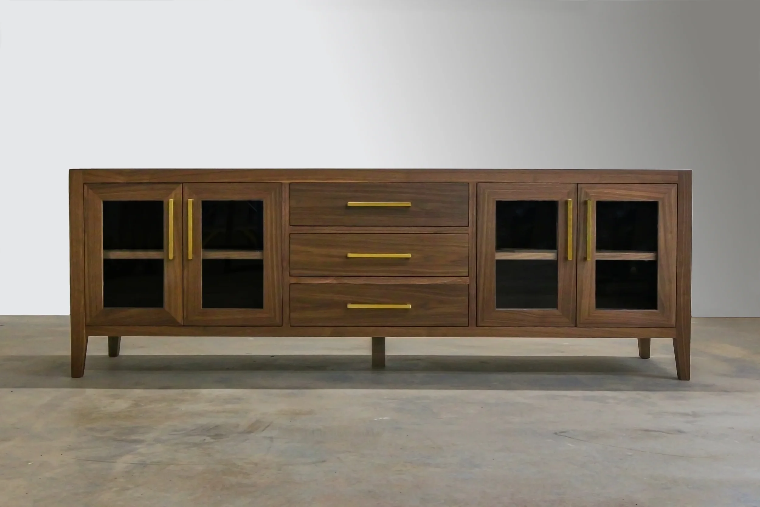 Walnut media console with glass doors