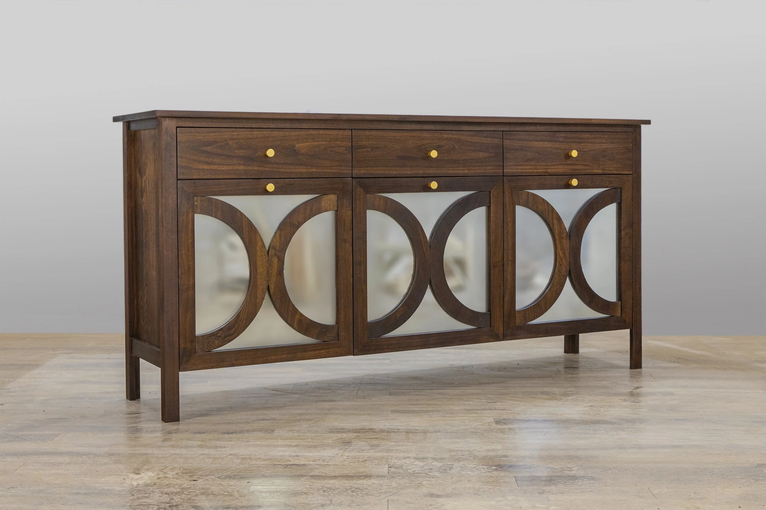 Walnut buffet with hand-cut dovetail drawers and decorative faces