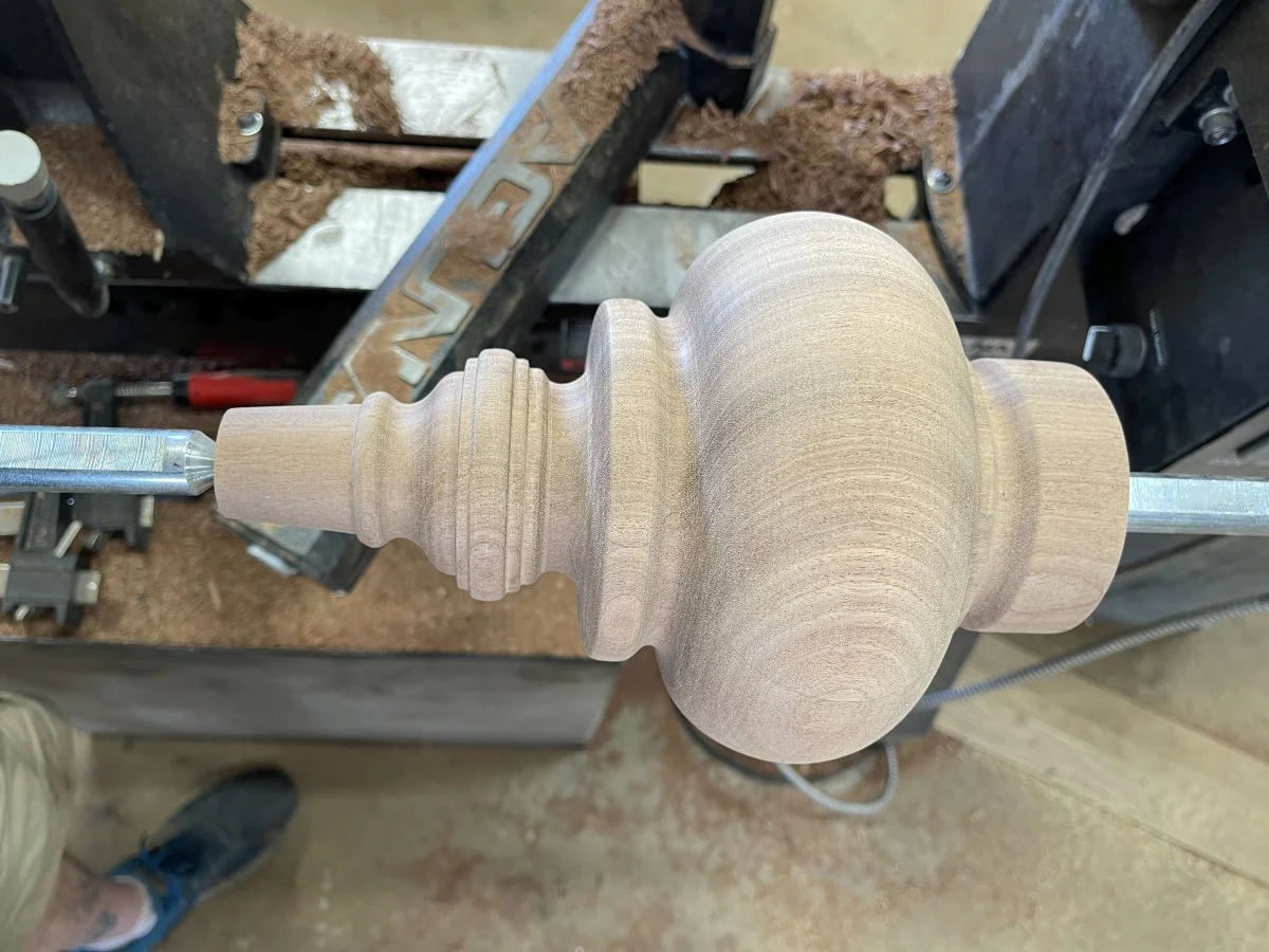 A detailed mahogany foot for a large cabinet piece