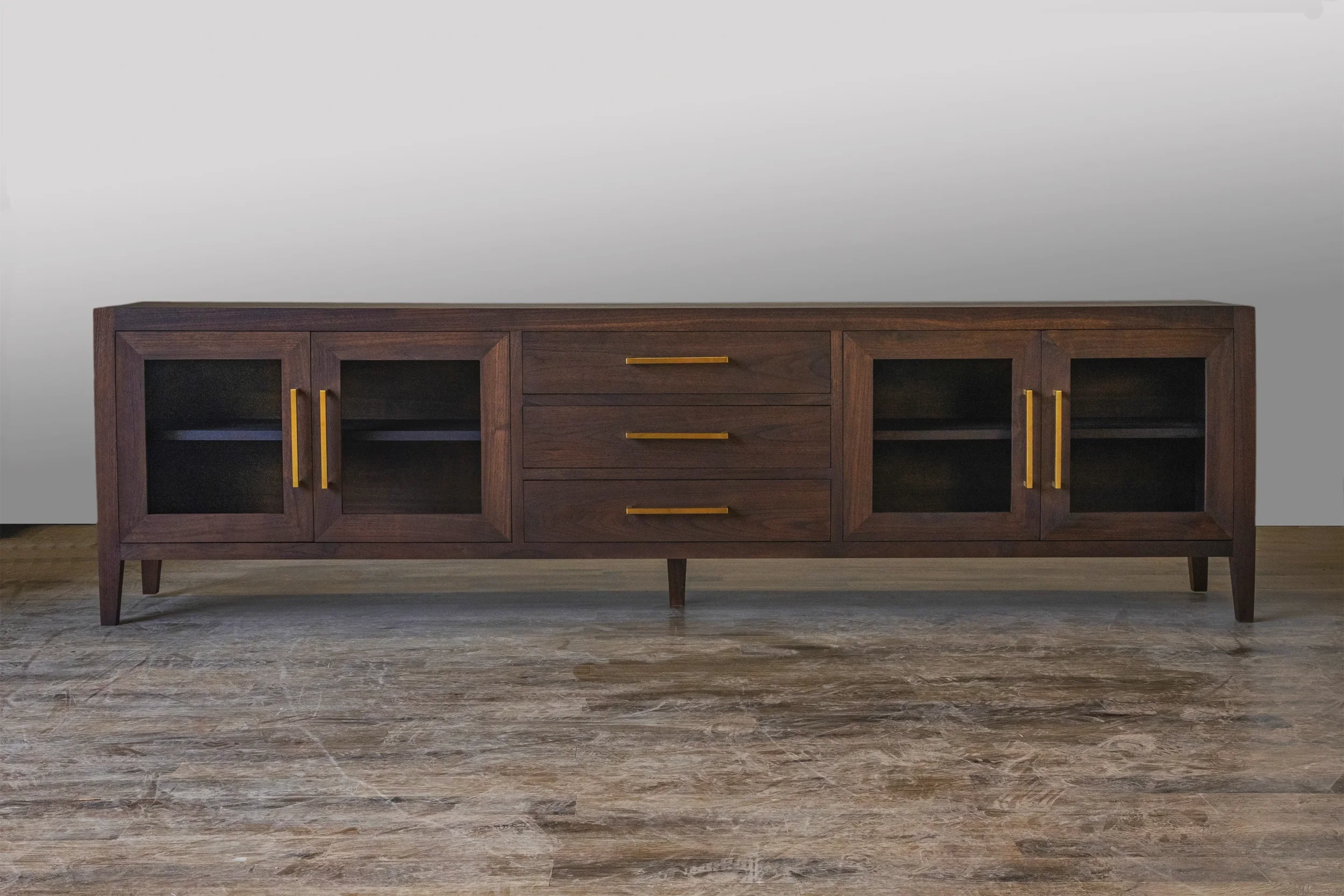 Walnut media console with glass doors