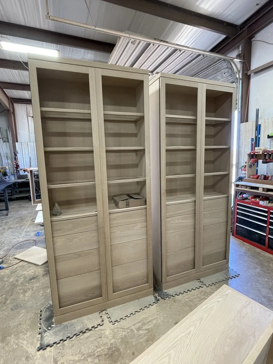 A set of White oak hutches getting their doors installed