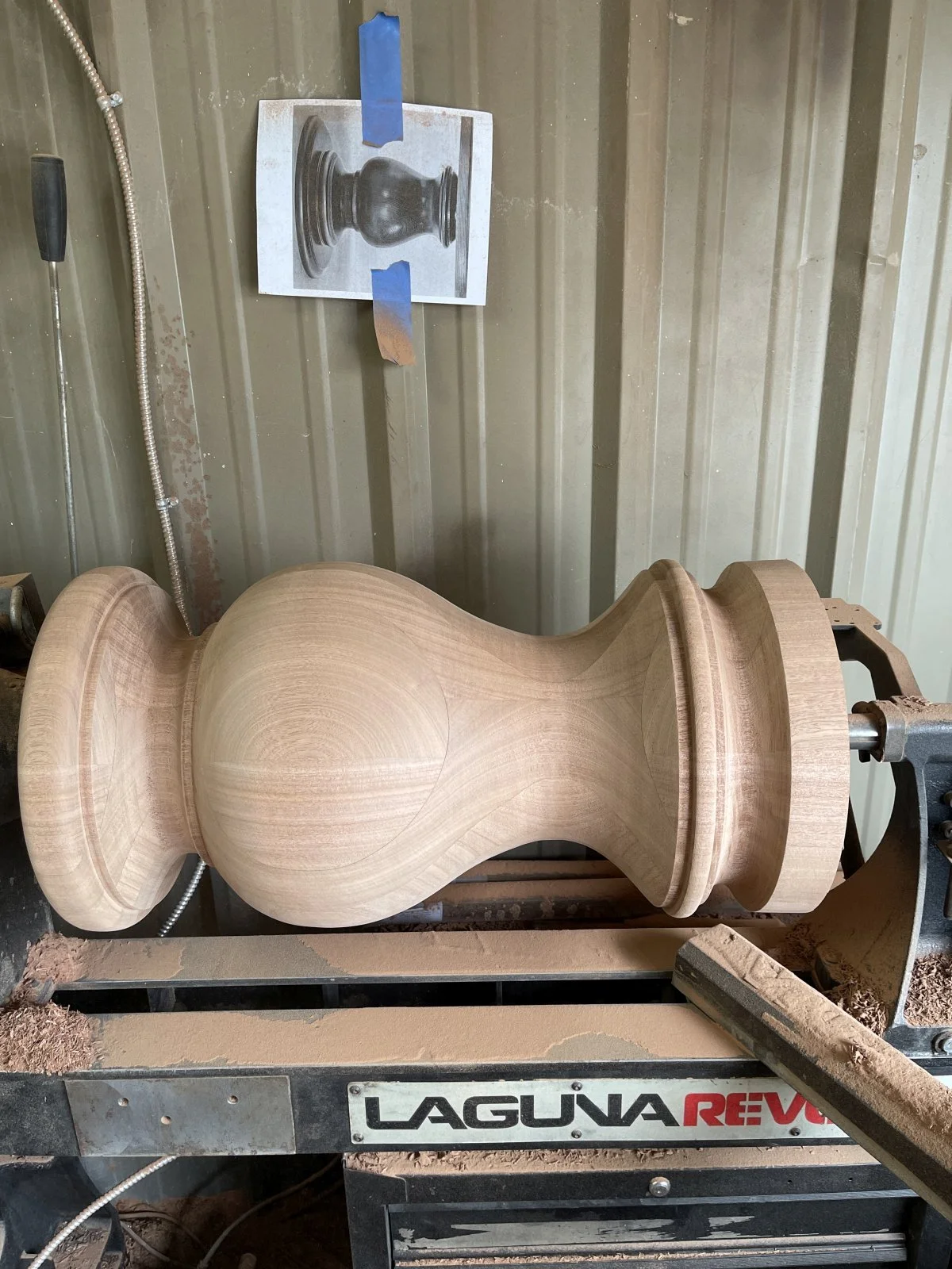 An newly completed mahogany pedestal on the lathe
