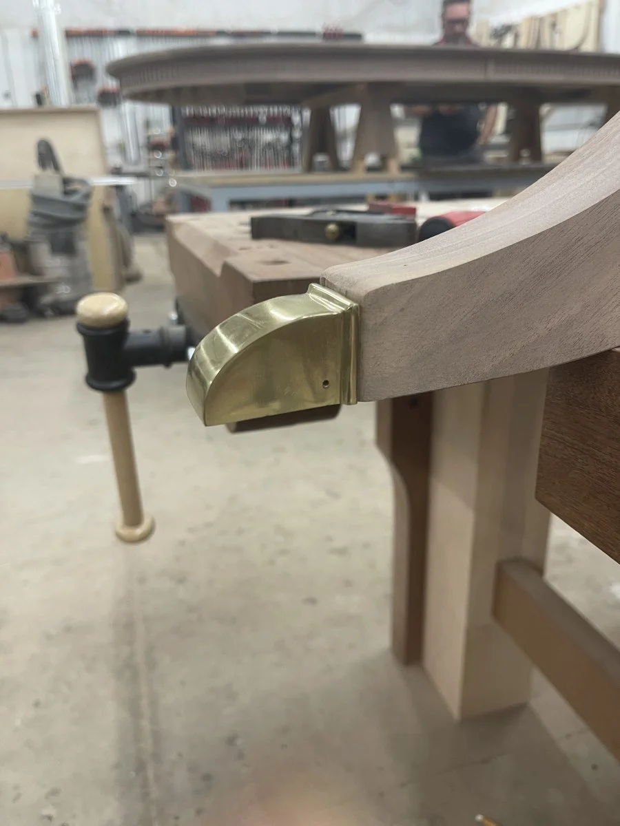 A Phyfe inspired table base getting its feet hand-cut for brass toes