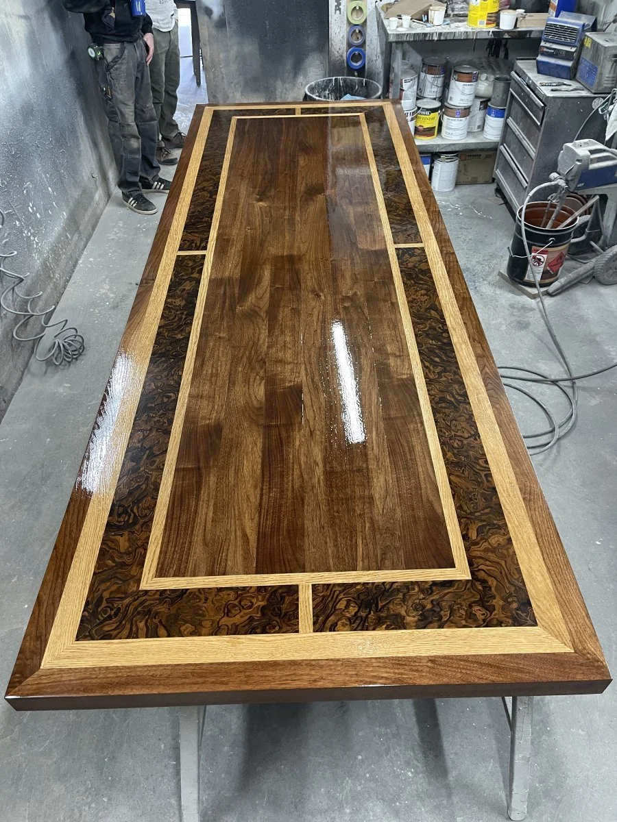 A huge Walnut, Burl and white oak patterned top after getting its second coat of catalyzed lacquer