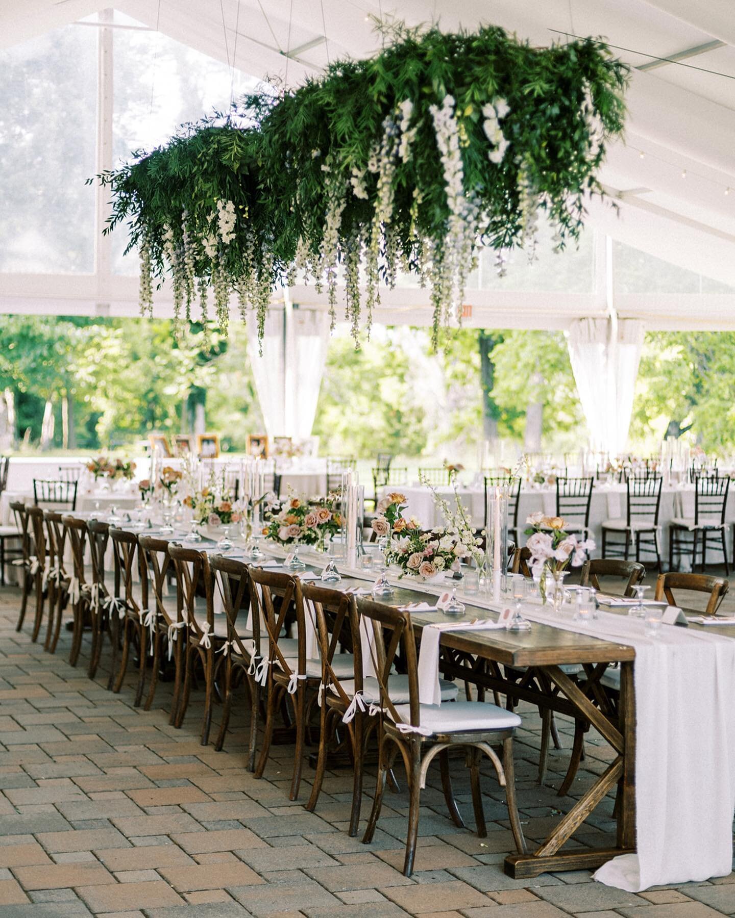 Hanging installations are one of my favorite things to create for my clients, especially in larger spaces like the @greenacresfoundation tent. For Lindsey and Ryan&rsquo;s June wedding we created a 15 ft long hanging delphinium install above the head