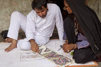 Designer Ishan Khosla and embroiderer Sajnu Ben design the Sangam logo