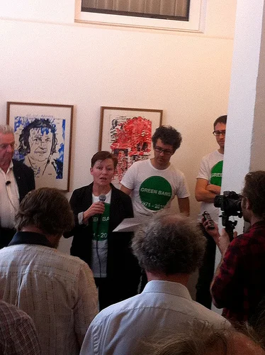 Project initiator and curator Jo Holder- director of The Cross Arts Projects discusses the awesome history of Green Bans and the genesis of the project to celebrate 40 years of Green bans. artwork on wall behind, original watercolours by Fiona MacDonald referencing historical material.
